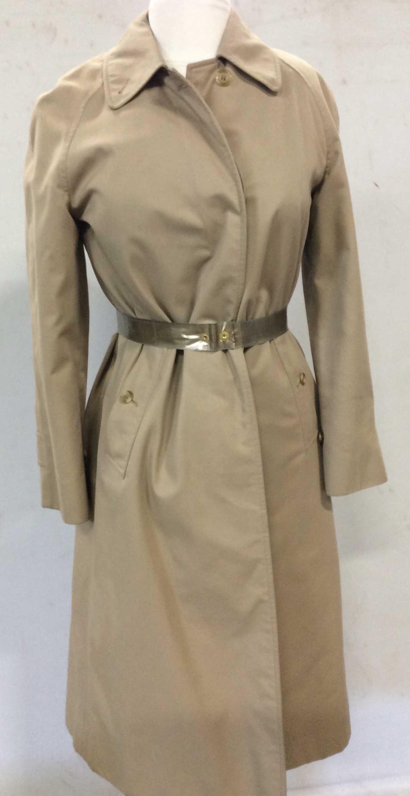 Authentic Burberry Cotton Trench Coat, England: This Burberry Coat is lightweight with classic Burberry Nova Check Fabric Lining. Care tag reads 51% Cotton, 49% polyester. Lining 50/50 cotton / poly. Deep side pockets with a button close, deep inte