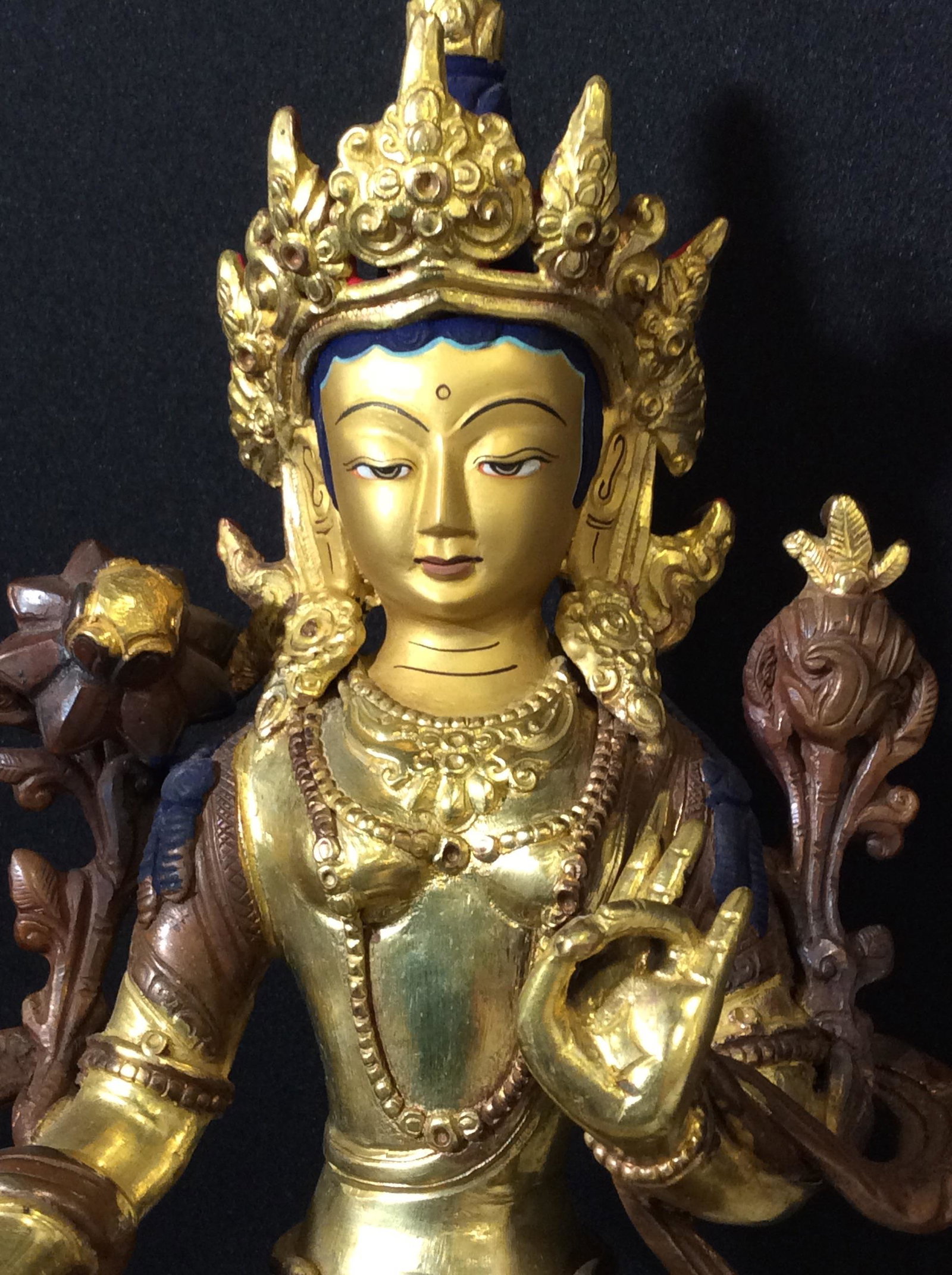 Bronze Gild Tibetan Goddess Statue: Sitting on a lotus, the Mahayana Buddhist Goddess Statue is vintage, a combination of bronze and Gild, wearing Ceremonial clothing and headdress. Ht 9 in. Width 6 in. Depth 4.5 in. Statue Bronze Gild,