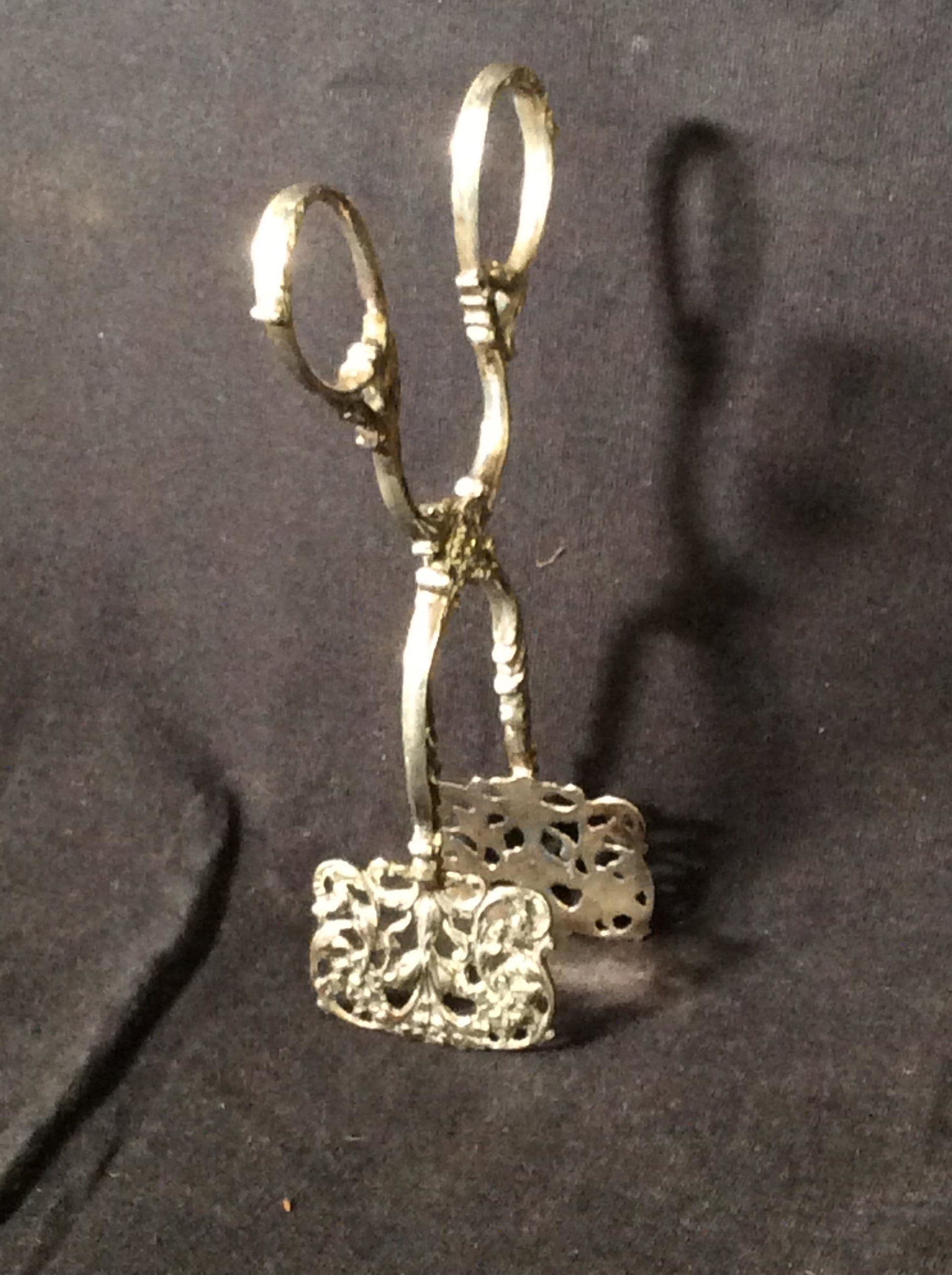 Sterling Silver Antique Petites Four Tongs,Germany: Art Nouveau Embossed Sterling Dessert Tongs, . 800 silver, impressed hallmark Near loop appears to be an ‘S’ with outer circle, measure 5 in. L, clamp app 1.5 in wide. Detailed florals and scrolls