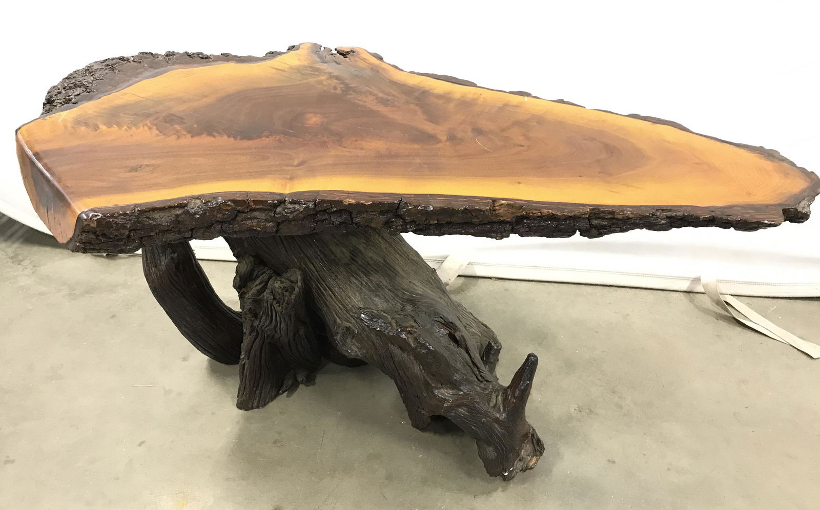 Organic Form Carved Wood Coffee Table: Carved wood coffee table, possibly vintage, possibly antique. Carved wood slab tabletop, tree root base. Glossy finish. Measures approx 17 inches H, 17.5 inches W, and 21 inches deep. Wear is consiste