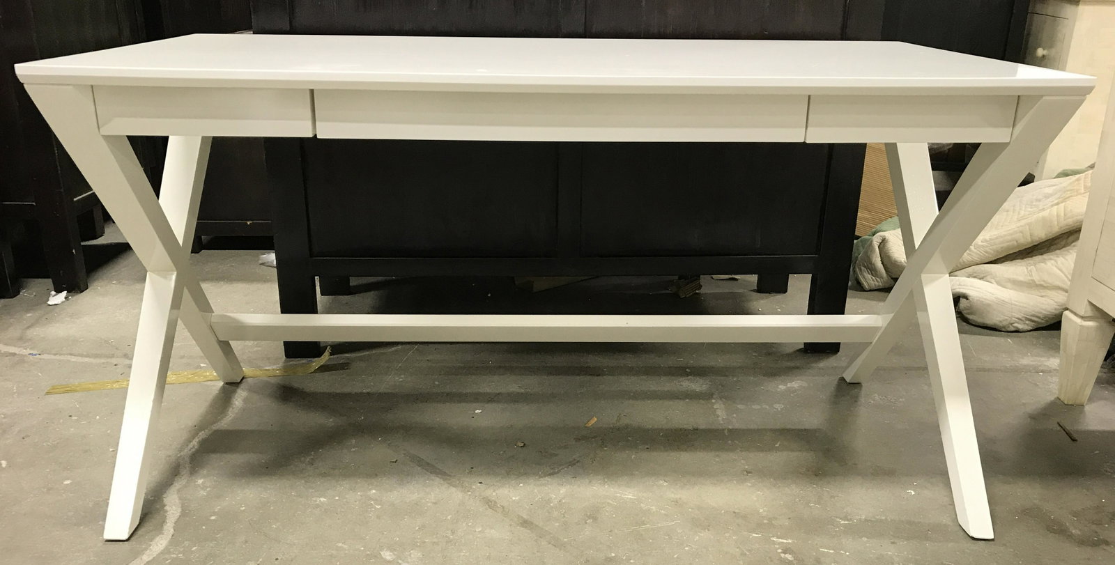 CRATE & BARREL White Toned 3 Drawer Desk: Desk is white toned. Piece has 1 large center drawer & 2 small side drawers. Desk supports are X shaped structures. Interior of left drawer has tag which reads CRATE & BARREL. Piece measures approxima