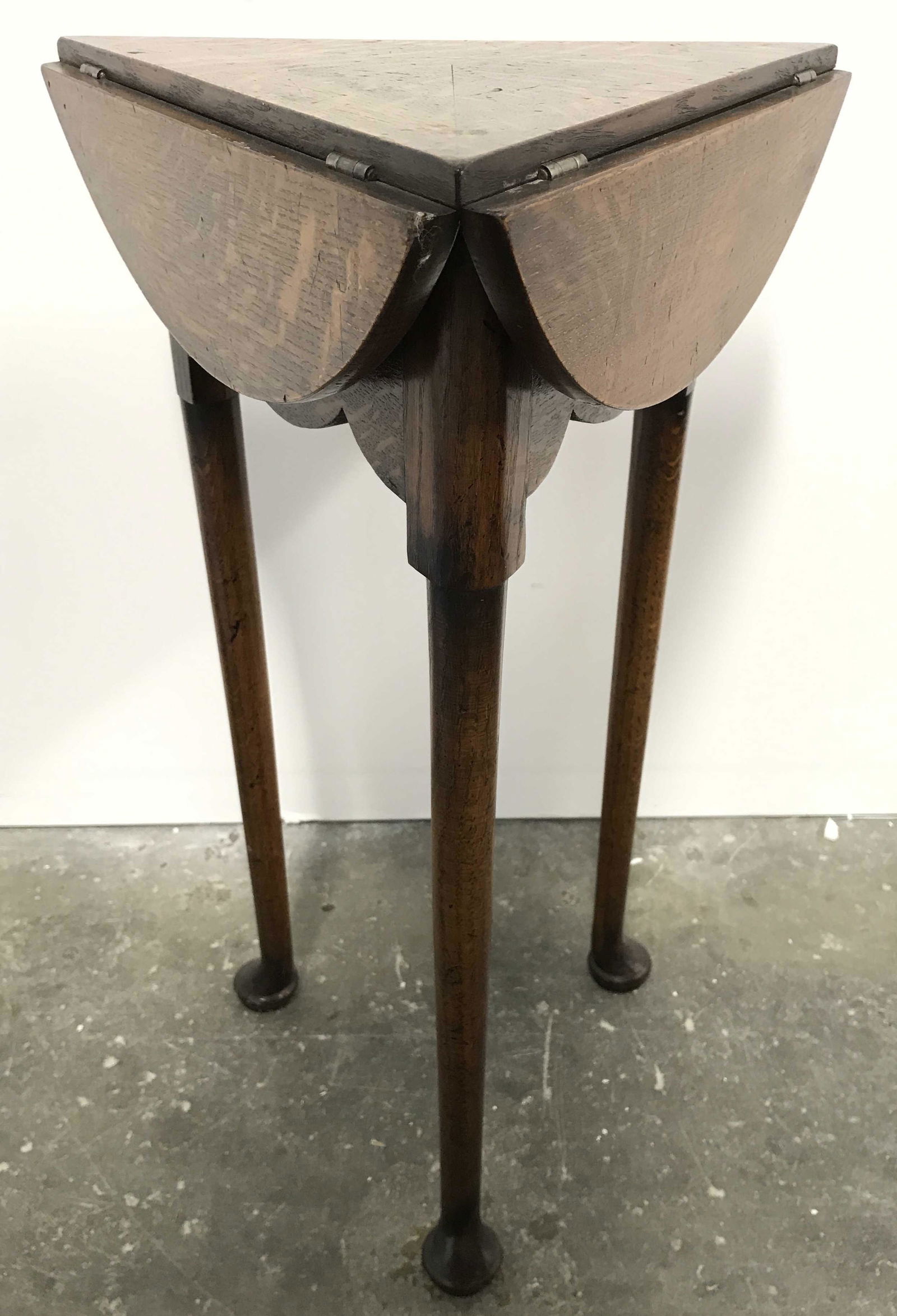 Vintage Carved Wooden Drop Leaf Side Table: Side table has 3 straight cabriole style feet. Piece is vintage possibly antique. Table has 3 drop leafs which stay supported with base rotated, triangular top, Piece measures approximately 24 inches