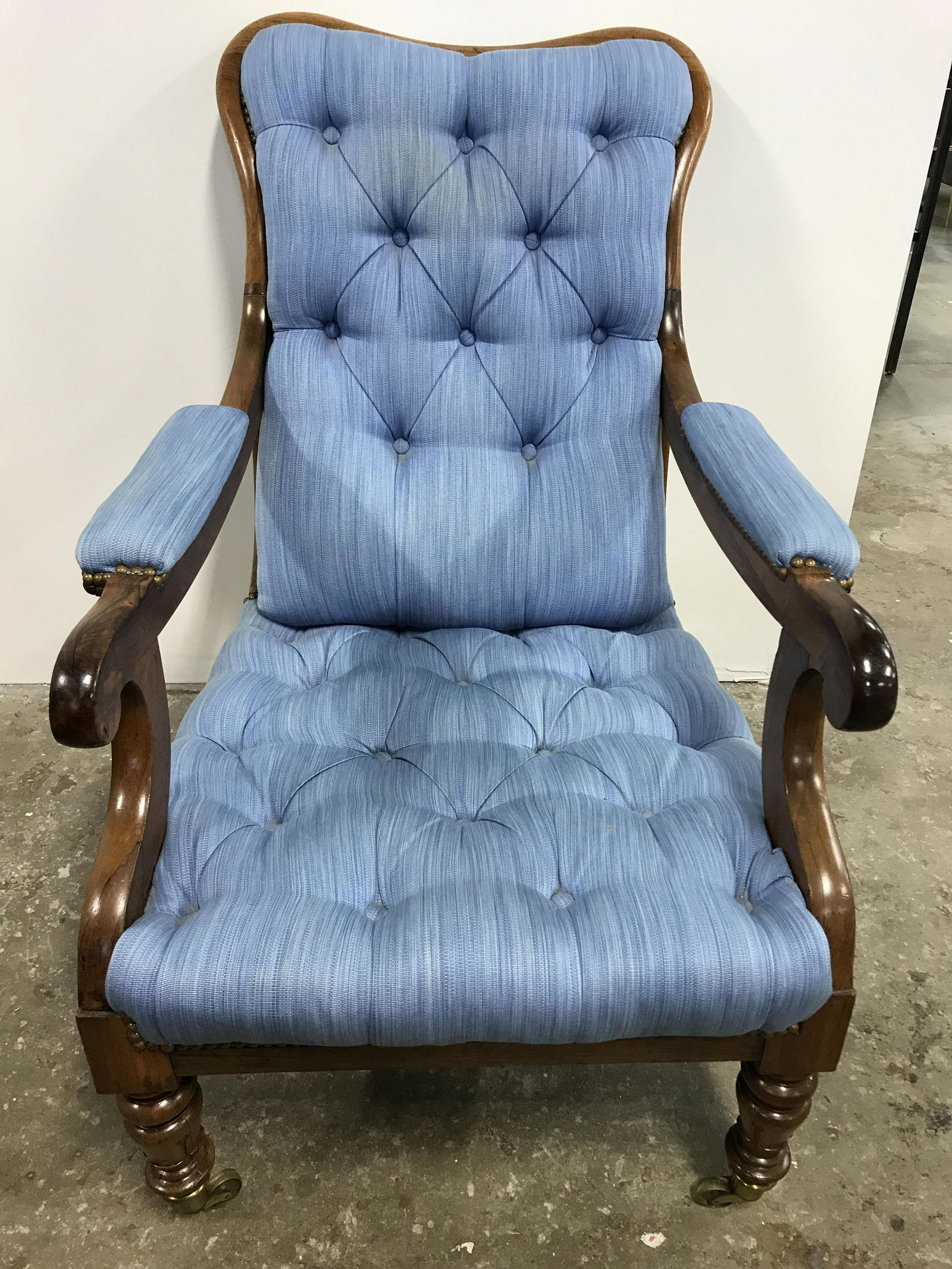 Vintage Tufted Bergere W Castors: Vintage Bergere on castors, possibly antique. Baby blue upholstery is secured to wood frame with brass nails, upholstery is tufted. Rear legs are saber shaped. Each leg rests on a brass castor. Measur