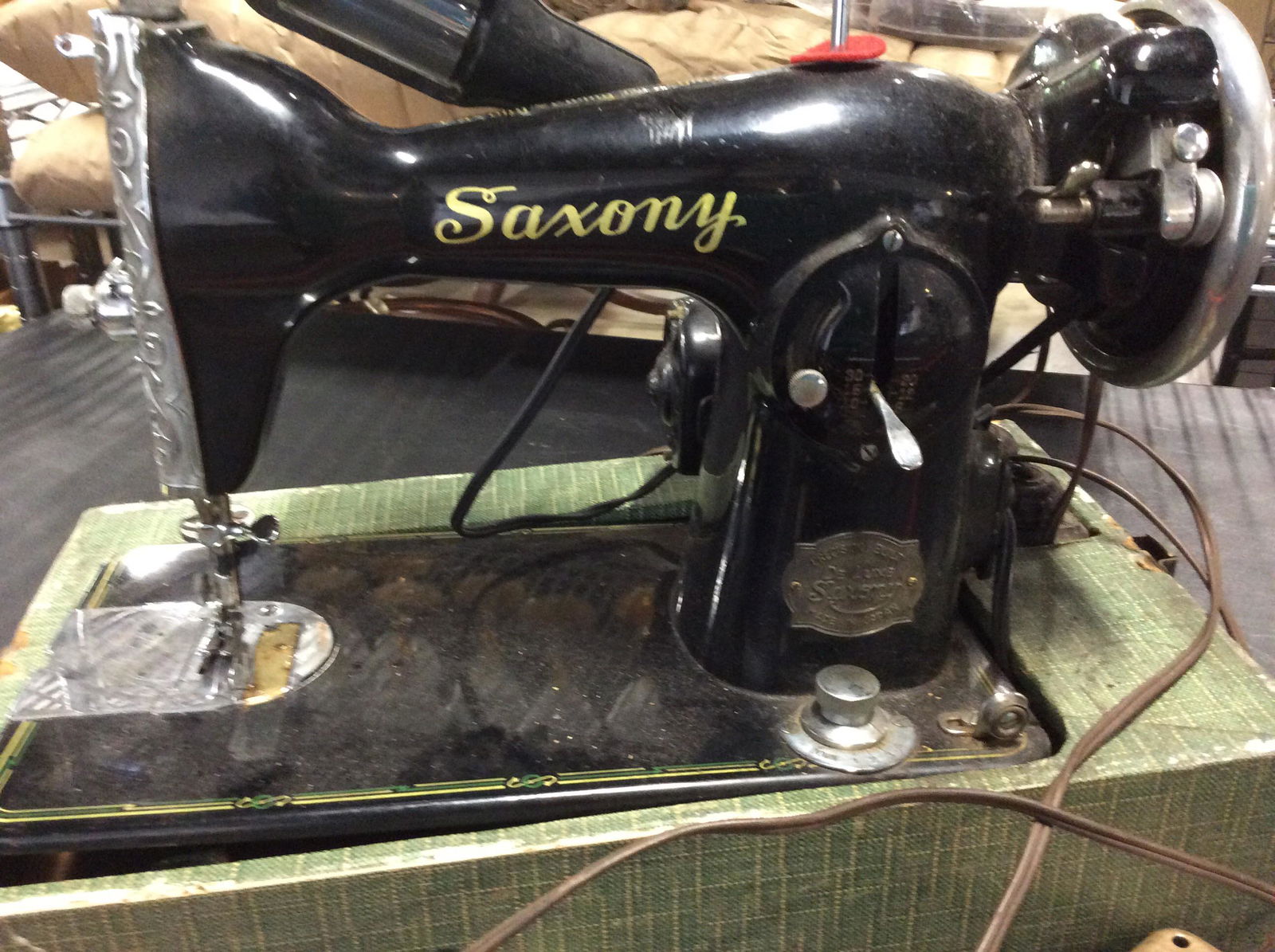 Collectible SAXONY SEWING MACHINE, Japan: Tabletop machine, possibly antique or retro 40s. Dr. Luxe Saxony, Made In Japan. Metal foot pedal that is attached to machine. Machine sits in box and is removable . Motor is a Champion Universal moto