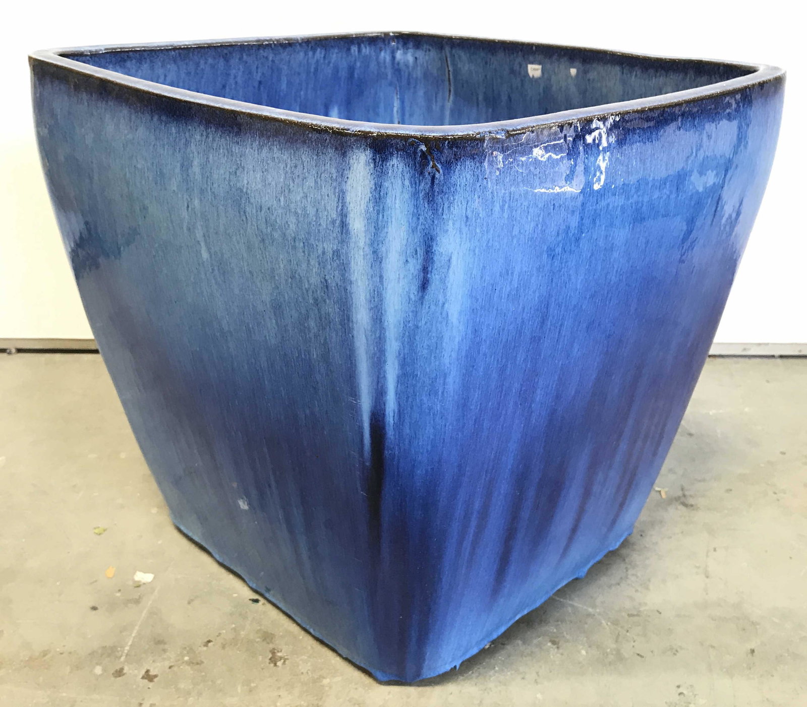 CAMPANIA Caribbean Blue Jeudi Ceramic Planter: Tag on piece reads CAMPANIA INTERNATIONAL JEUDI PLANTER CARIBBEAN BLUE. Planter is ceramic. Piece is possibly hand painted. Measures approximately 15 inches tall 16 inches wide and deep. Planter, cera