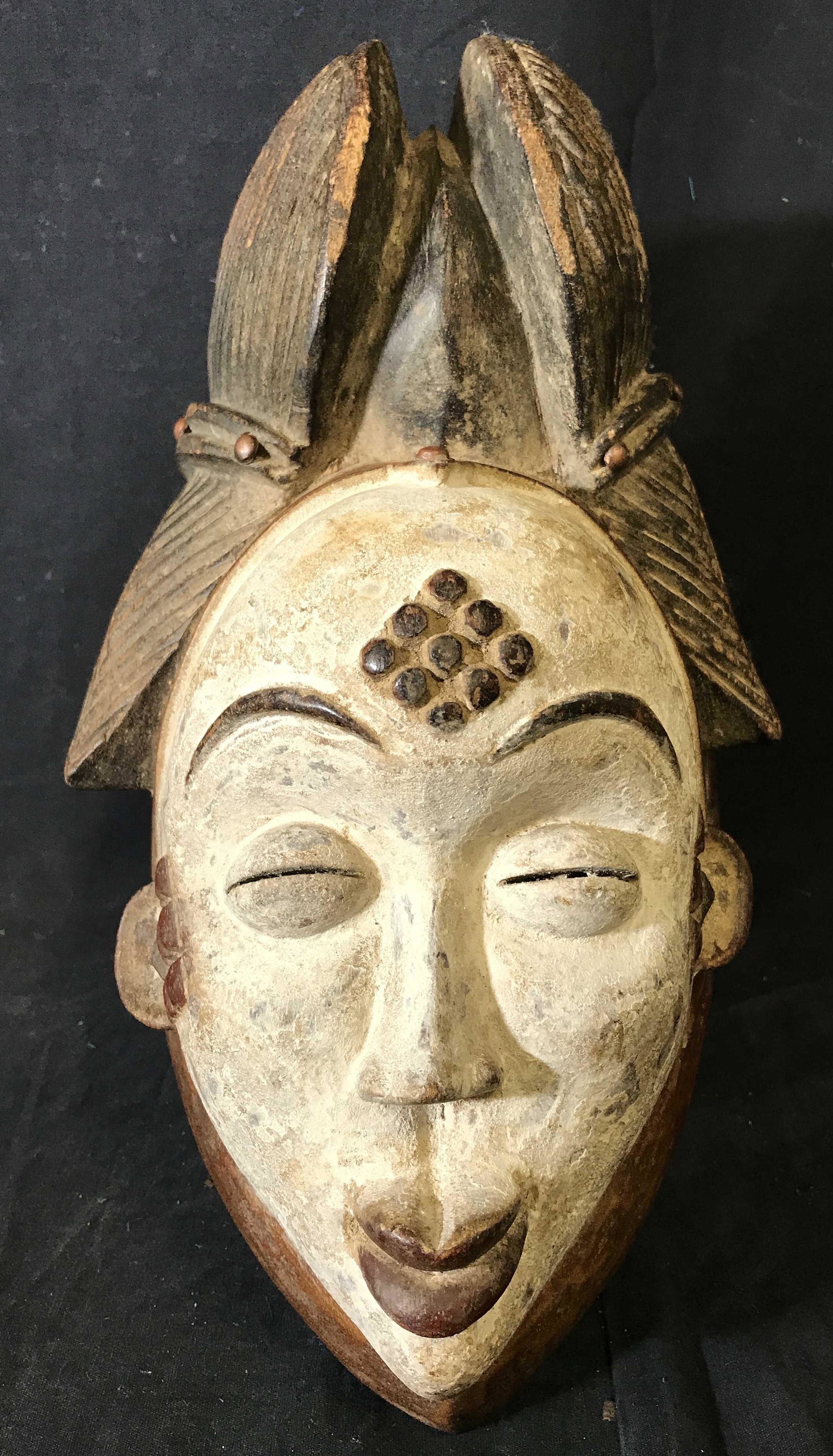 White Gabon Punu Face Mask: White Gabon Punu Face Mask, origins can be found in Gabon Central Africa, hand carved from one block of wood, painted with brown red white and black pigment and metal studs, a Punu mask is usually use