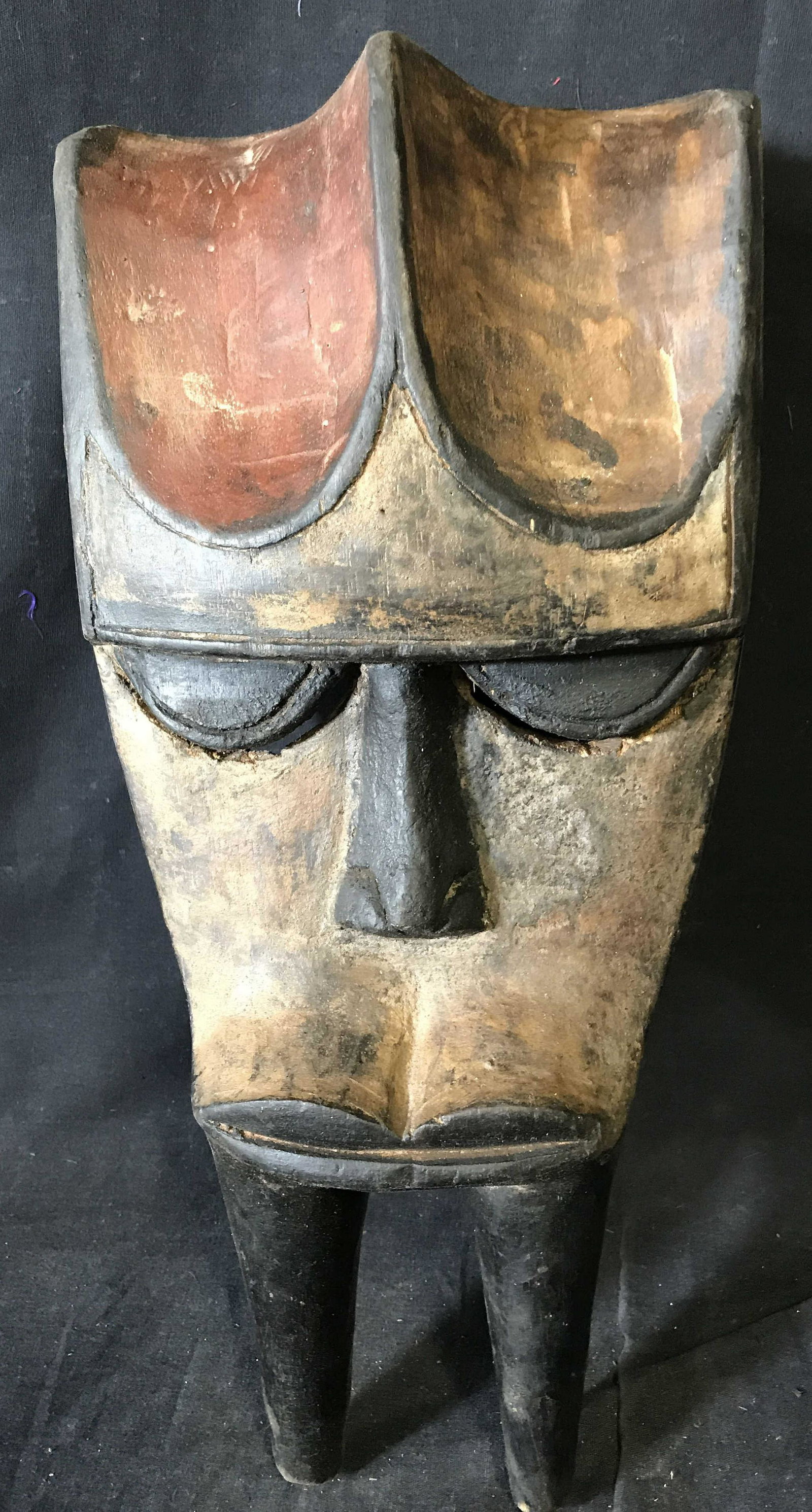 Gabon Kwelet Mask: Gabon Kwelet Mask, origins can be found in Gabon Central Africa, hand carved from one block of wood, painted with red brown and black pigment, approximately 17 inches at tallest point and 8 inches at 