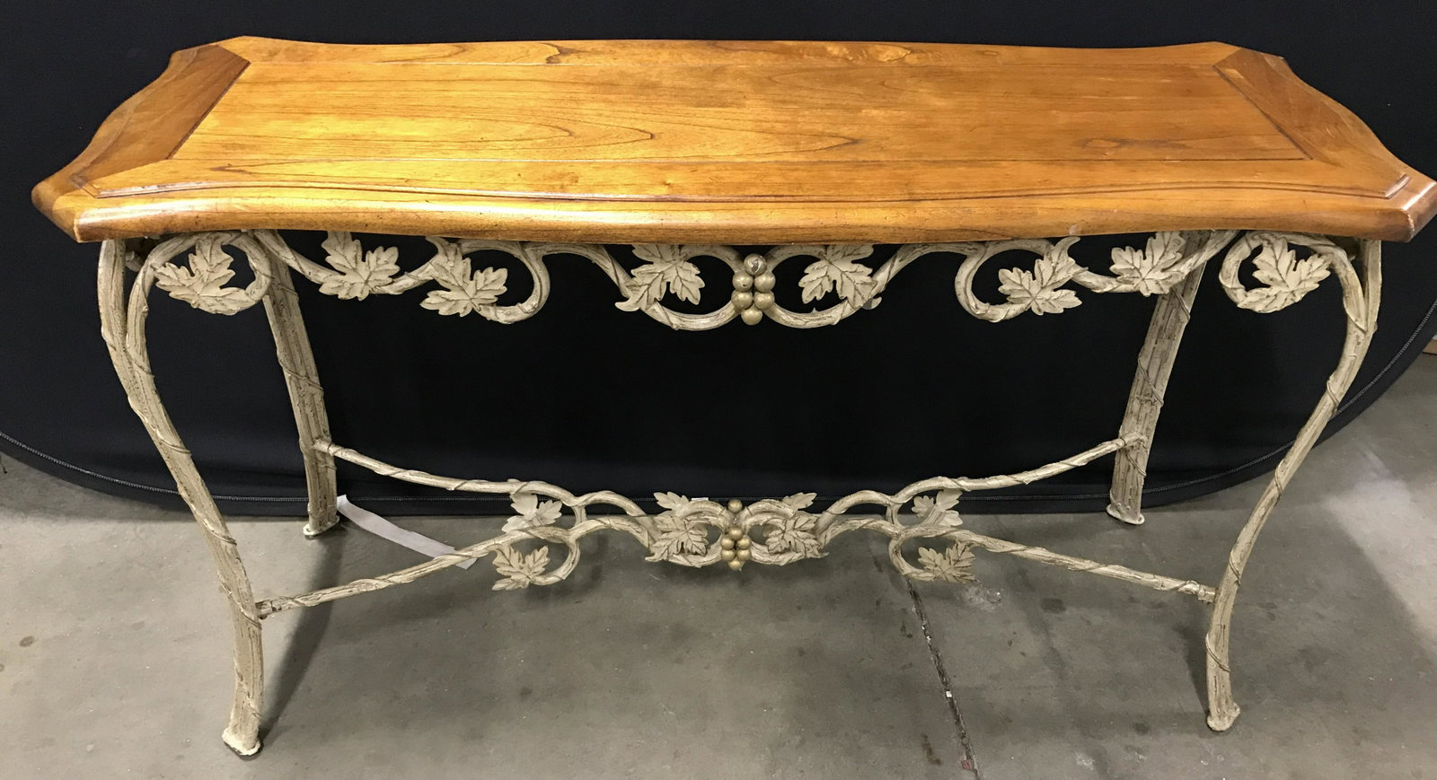 Vintage Wood & Metal Console Table: Vintage console table. Table top is carved wood, frame is metal. Metal frame has been constructed to resemble Vines, leaves, and grapes, frame is colored in bone tones. Measures approx 28.5 inches H, 