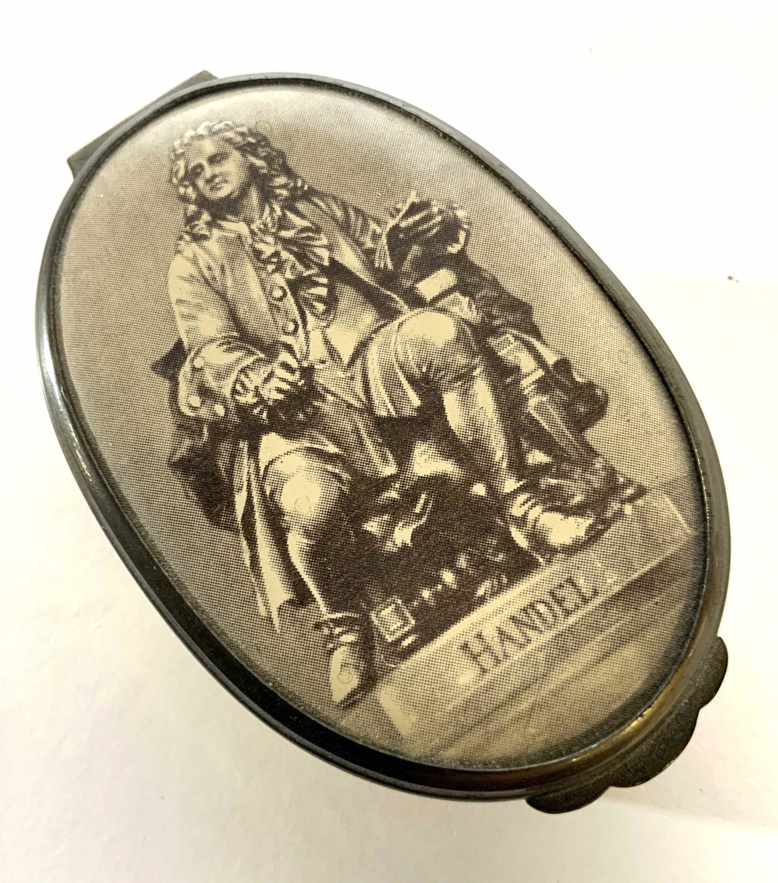 CARTIER Luxury Toleware Pill Box, England: A trademarked BILSTON & BATTERSEA ENAMELS Trinket box / pill box with a transfer print of HANDEL on Reads Cartier New York Hallmarked No. 450, also marked Bilston and Battersea Enamels Made In Englans