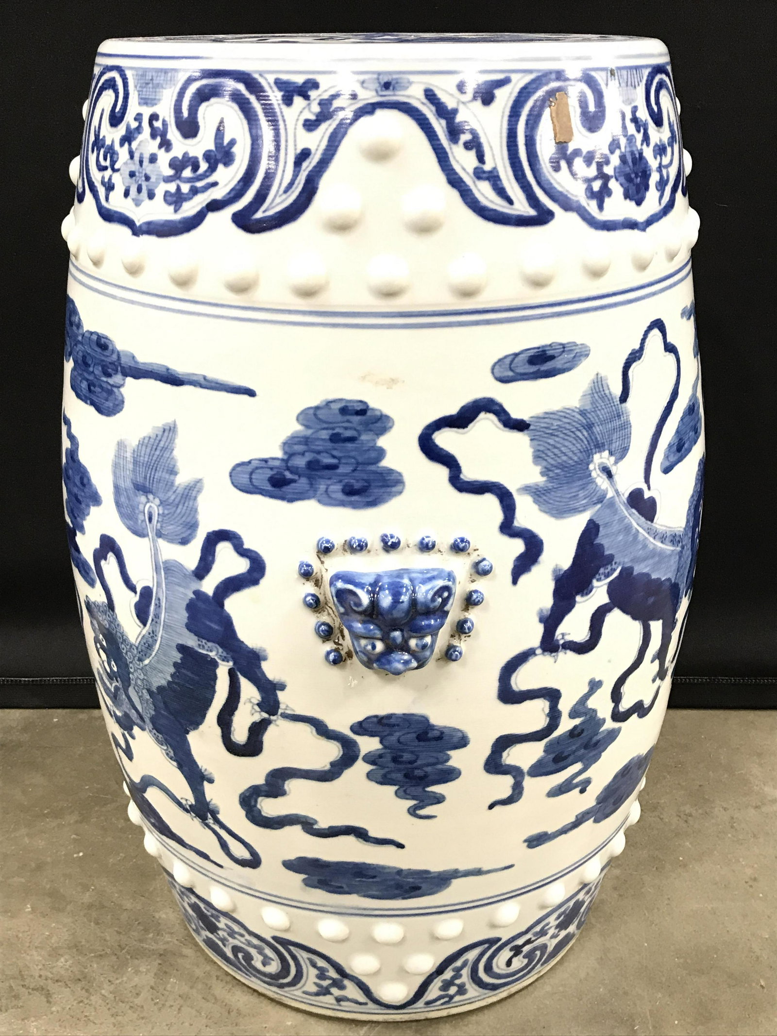 Porcelain Asian Chinoiserie Garden Stool: Garden stool is porcelain. Piece is white with blue toned floral, vine, a leaf, dragon and foo dog detail. Piece appears to possibly be vintage. Asian arts and Crafts, chinoiserie, garden stool, Cizho