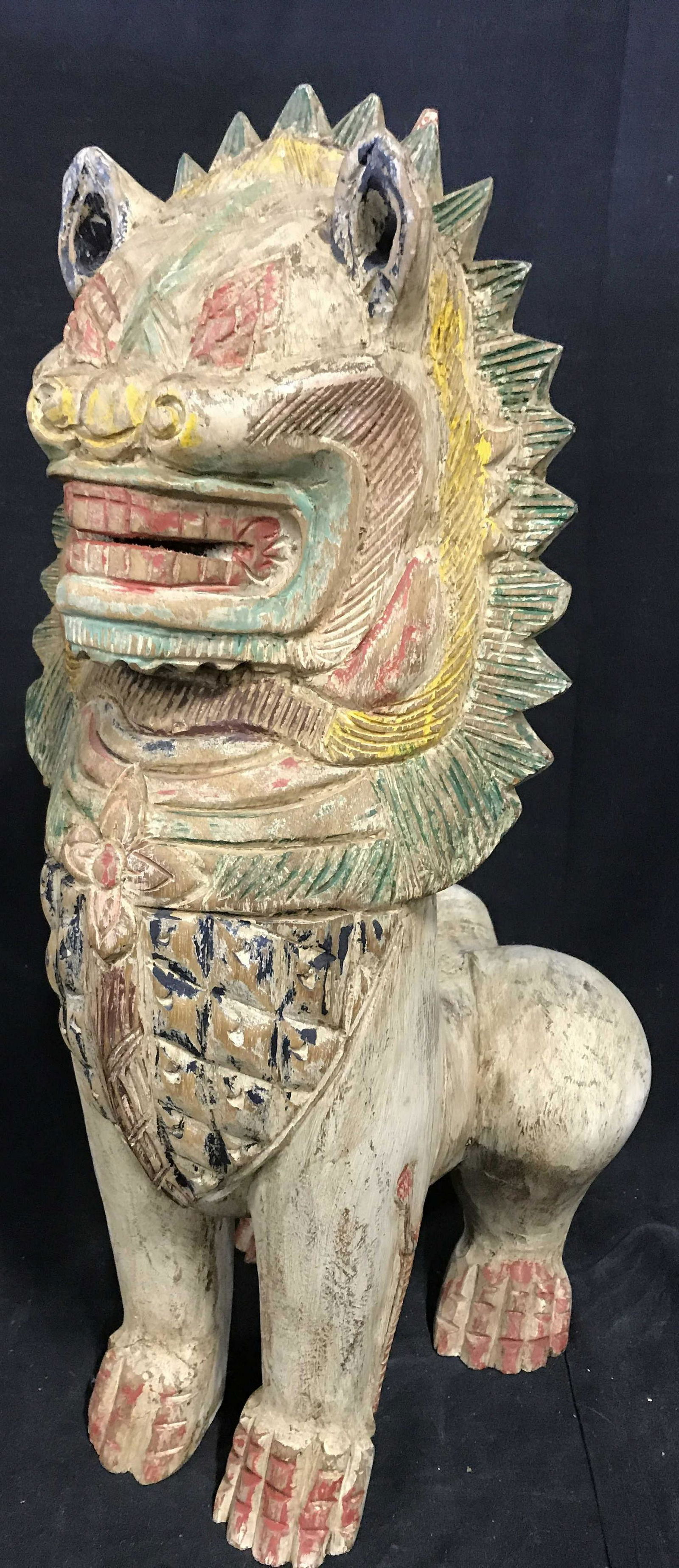 Vintage Floor Sized Carved Wood Foo Dog: Carved wood Foo dog. Sculpture is vintage, possibly antique, and hand painted in various tones. Sculpture is hand made. Measures approx 22.5 inches H, 10 inches W, and 13 inches deep. Wear is consiste