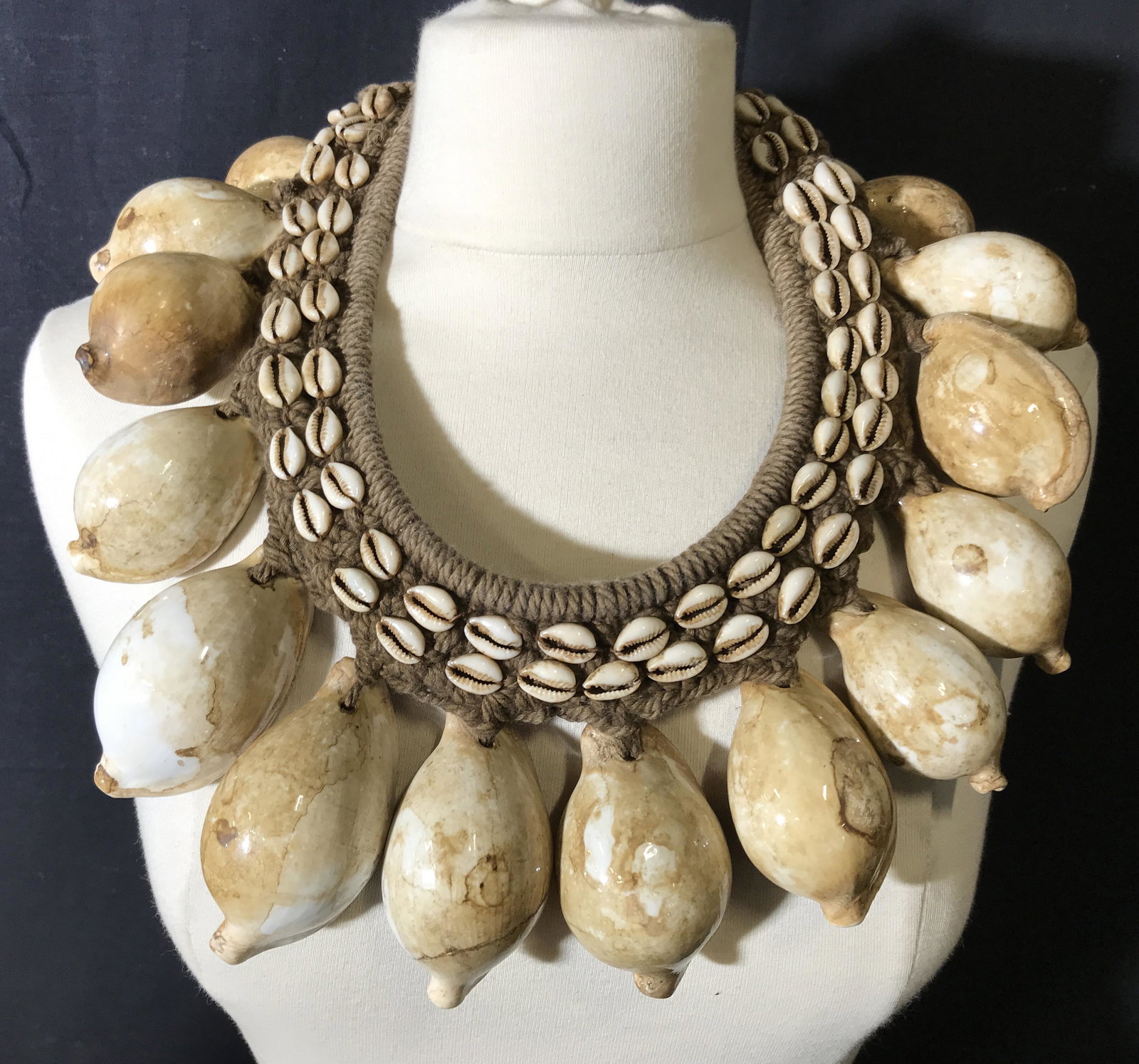 Tribal African Seashell Necklace: Tribal African necklace, made of brown braided rope with large tulip cowrie shells and small cowrie shells making up the collar, shell and rope loop make up the latch, inner collar measures as a 9.5 i