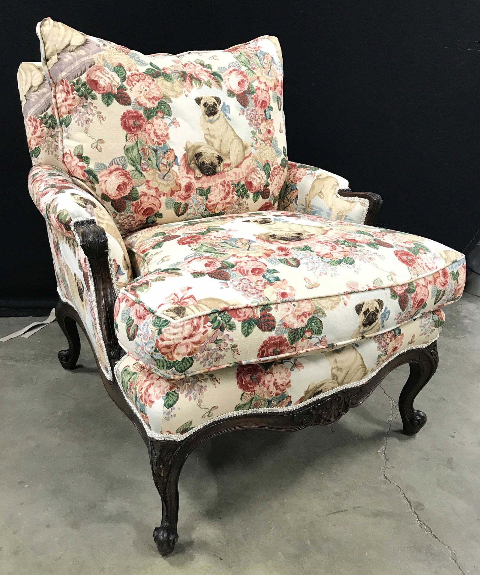 Vintage Pug & Floral Detailed Upholstered Bergere: Bergere is upholstered Is upholstered with pug, floral and leaf detail. Piece contains intricately carved wooden detail. Piece has decorative welting at edges of upholstery. Piece measures approximate