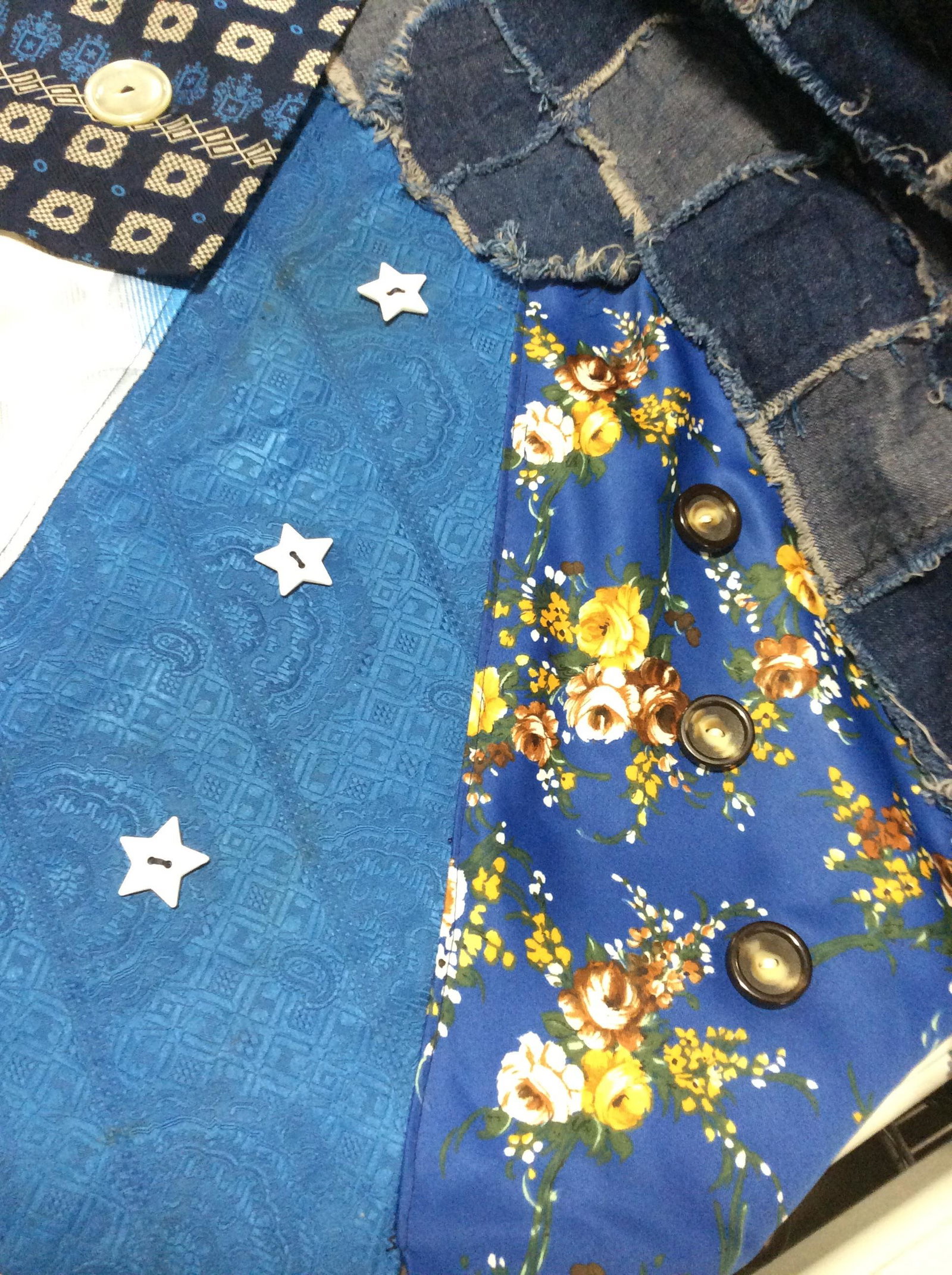 Handmade Multi Textile Costume Tapestry: Made out of silks, Buttons, Blue Jean, & cotton backing. This piece was used as a stage prop for plays. Pieces of vintage fabrics cut and made to resemble large ties, displayed in a fan with vintage b