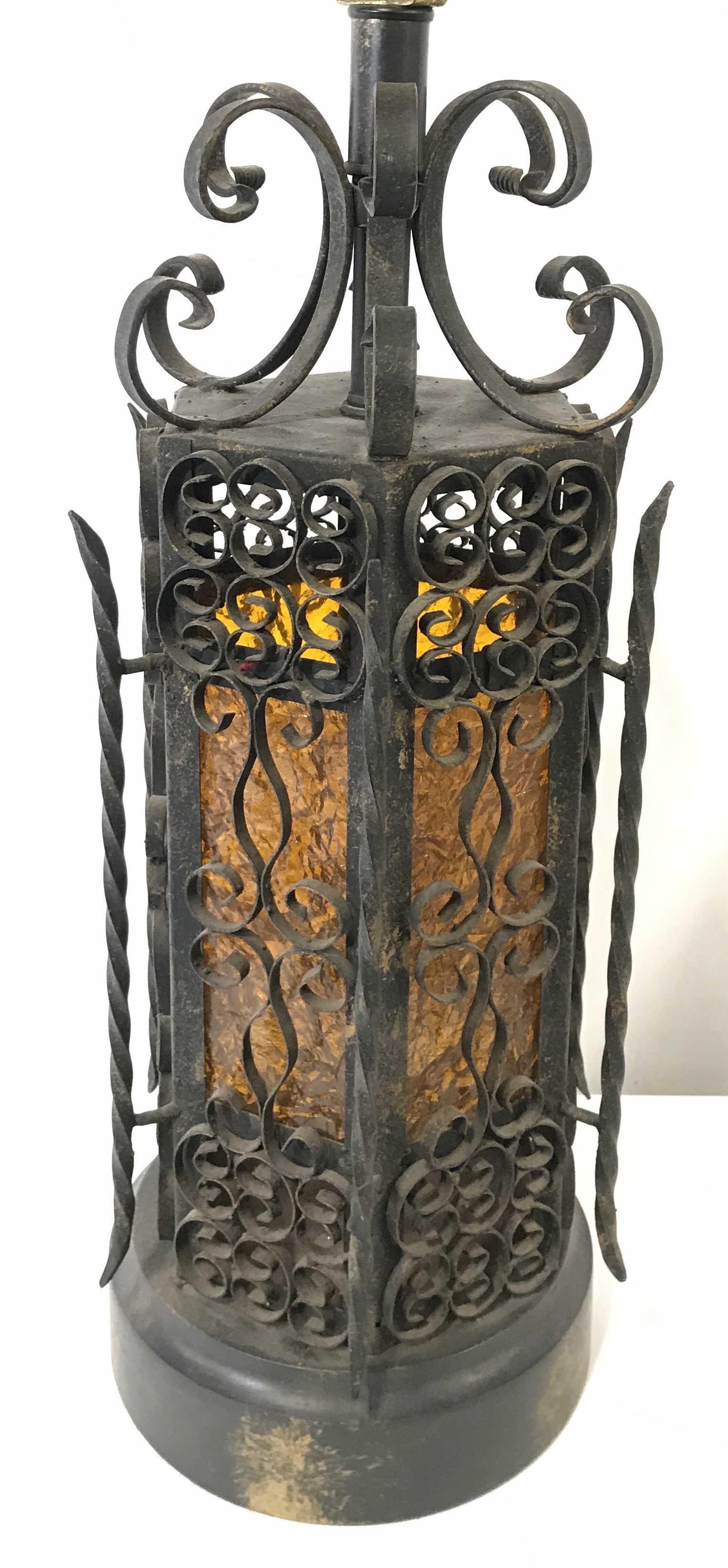 Vintage Metal Lamp & Art Glass Lamp: Lamp is vintage possibly antique. Piece is metal with amber toned art glass in center. Piece has metal c and s curve structures. Piece has small twist switch. Piece measures approximately 24 inches ta