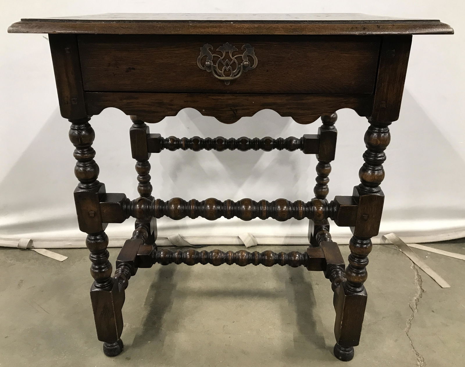 Vintage Carved Wooden Side Table W Drawer: Side table is wooden. Piece is vintage possibly antique, appears to have some hand crafted elements. Drawer has hand dovetailing. Piece have intricately carved legs and stretchers. Drawer handle is go