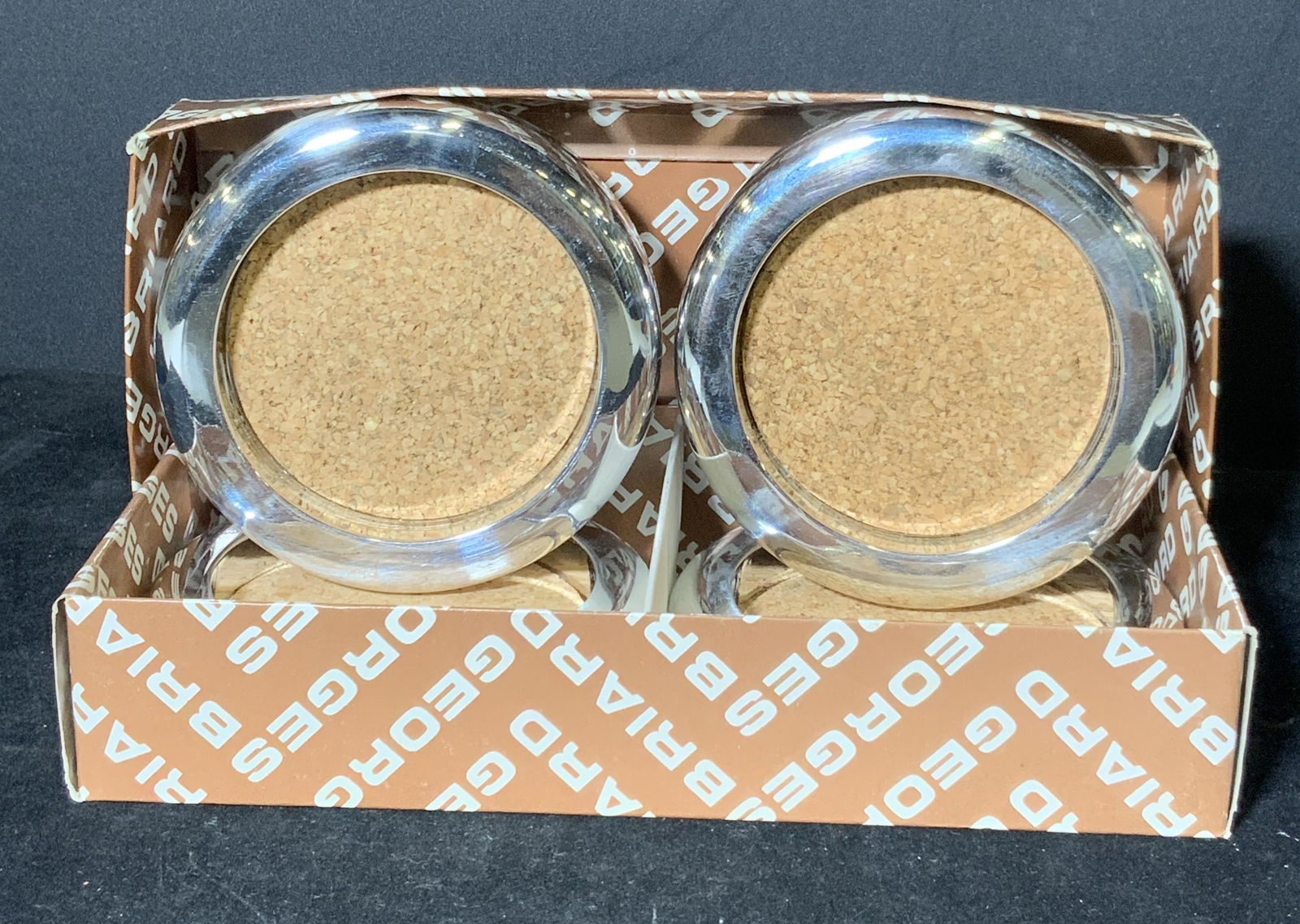 Set 4 Vintage George’s Briard Chrome Cork Coasters: Set of 4 chrome & cork style coasters. Vintage set from Georges Briard. Light weight plastic and in good vintage condition. Comes with original Georges Briard box. Underside reads: Georges Briard, Tai