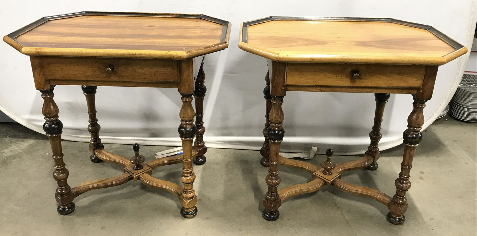 Pair Carved Wood Octagonal End Tables: Carved wood end tables, vintage, possibly antique. Tables are octagonal, drawers are dovetailed, drawer pulls are metal. Legs are turned and two toned, legs are joined by an X shaped stretcher, finial