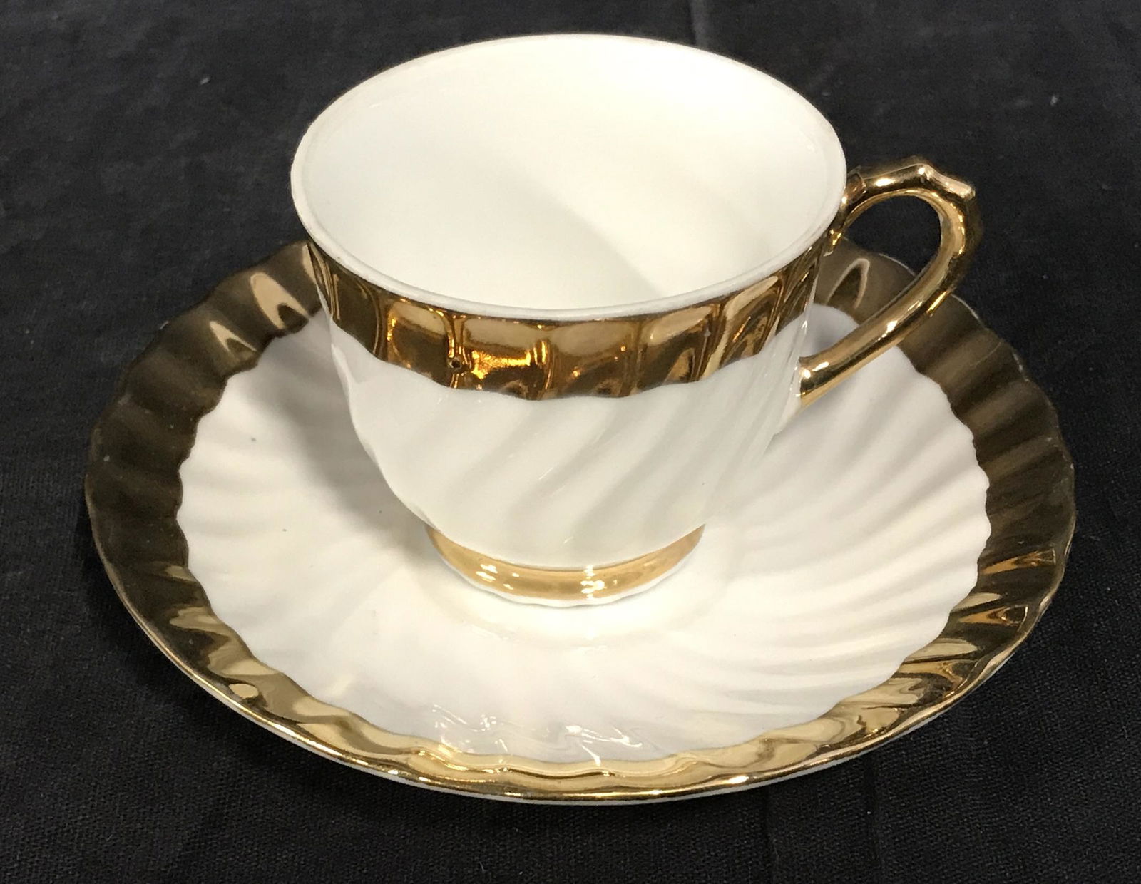 Gilt Porcelain Teacup & Saucer: Gilt Porcelain Tea Cup and Saucer, underside of cup and saucer reads ‘Porcelaine Elegance 22/967’, both cup and saucer have a gilding to the rim, saucer measures 5 inches in diameter cup measures
