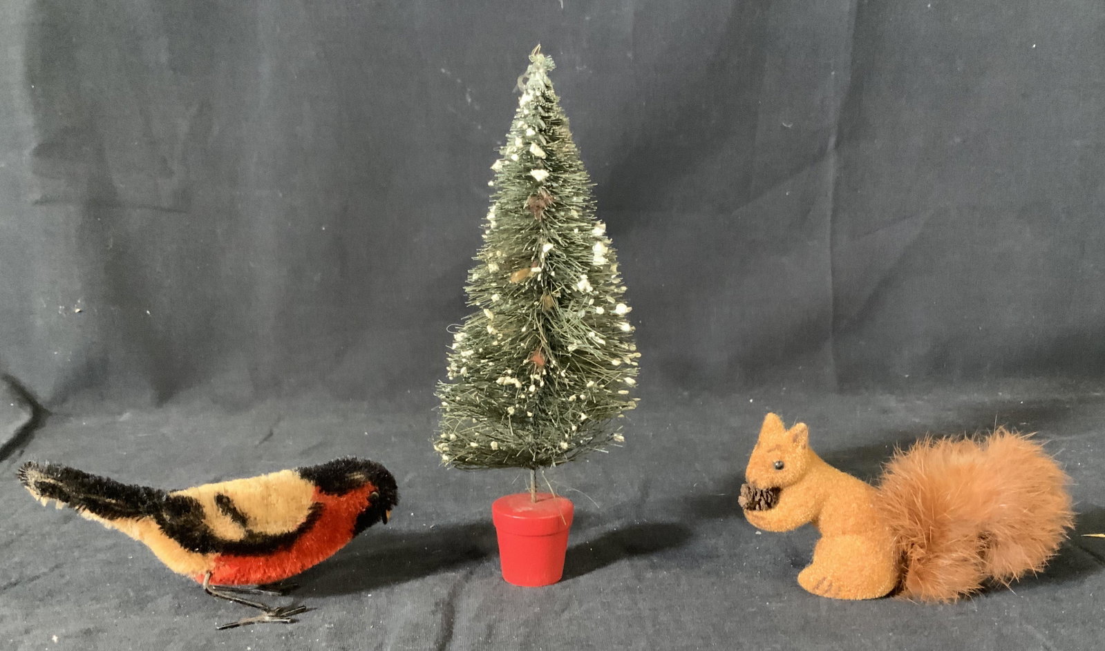 Lot 3 Christmas Figurines: Lot 3 Christmas Figurines, label to base of squirrel reads ‘handwork kunsterscutz West Germany’, squirrel measures 2 1/4 inches tall x 2 2/4 at widest point, tree measures 7 inches tall x 2 1/8 in