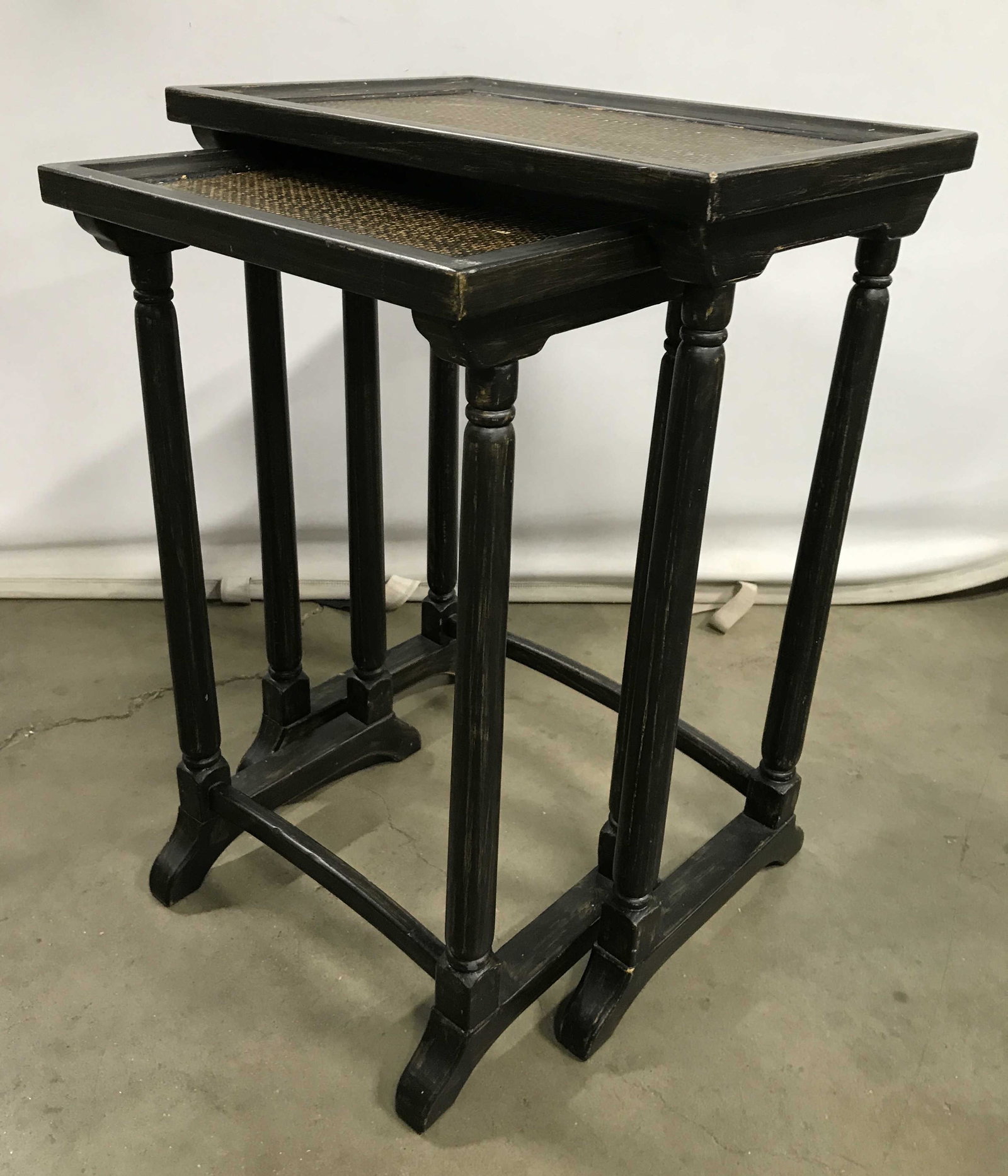 Set 2 Vintage Asian Wooden Nesting Tables: Nesting tables are vintage and wooden. Lot includes 2 tables. Tabletops appear to possibly have woven Structures. Largest piece measures approximately 25 inches tall 19 inches wide 14 inches deep. Nes