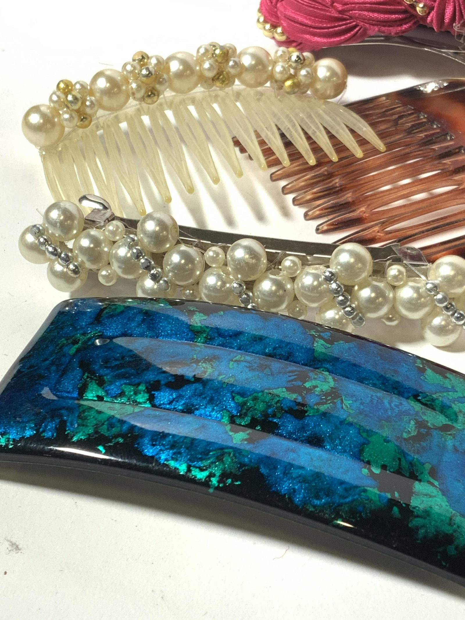 Lot 10 Hair Accessories, Clips & Combs: Assorted vintage & contemporary vintage style hair clips and hair combs. A mix of fabric, pearls, and crystals. Gold & silver toned clips adorned with pearl clusters. Bakelite style & enamel clips. To