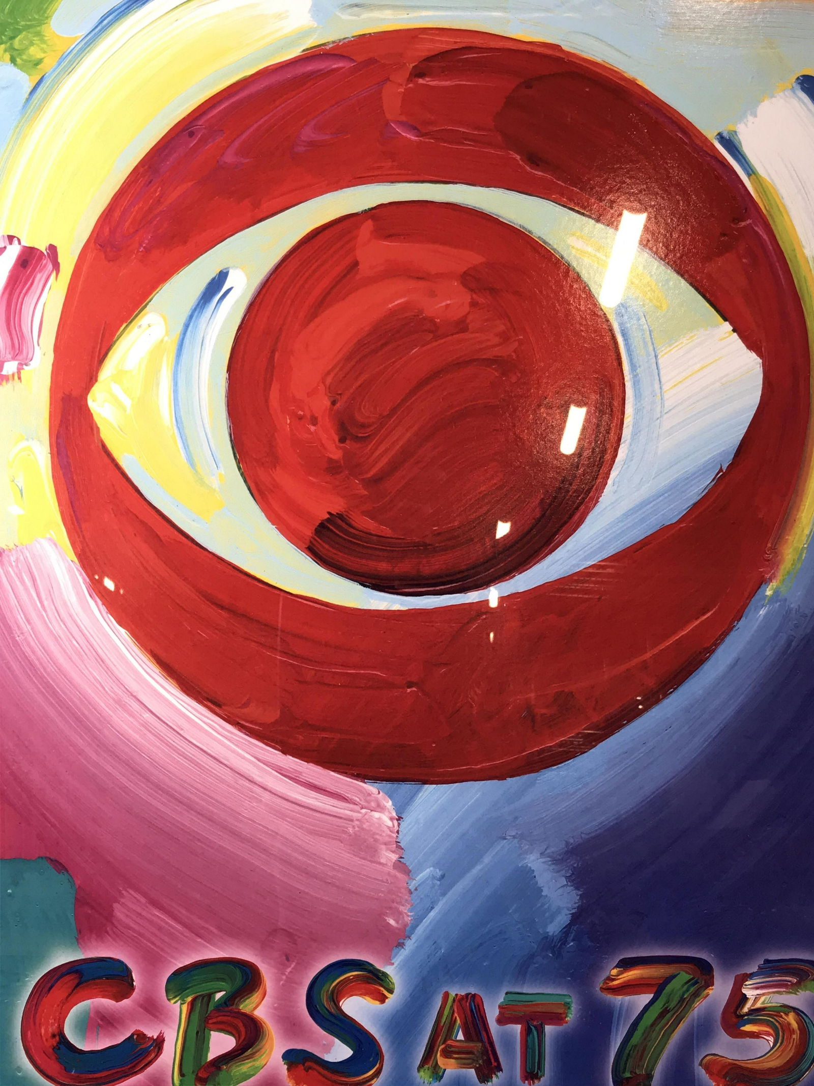 Framed CBS at 75 Advertisement Poster, Peter Max: Framed CBS at 75 Advertisement Poster, text to lower section of poster reads ‘CBS at 75’, printing logo to lower border reads ‘Peter max, Petermax.com’, subject the CBS Eye logo made to look l