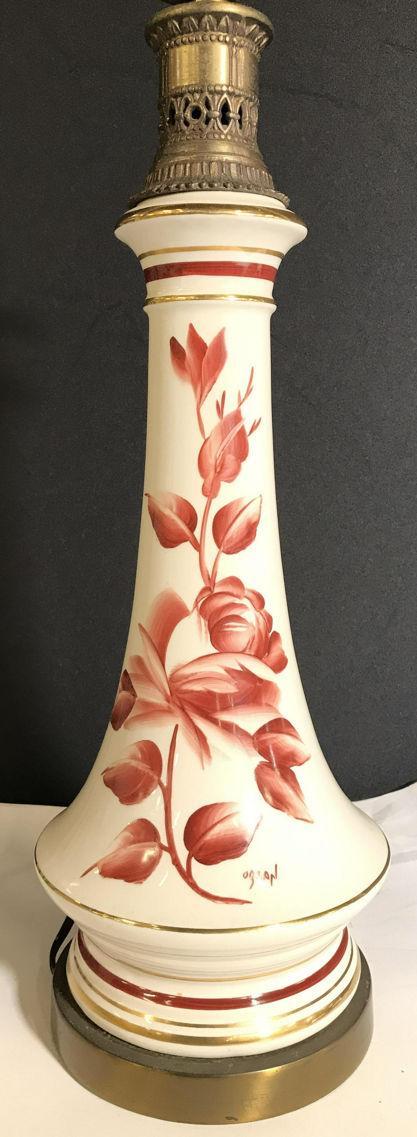 OZLAN Hand Painted Porcelain Lamp: Lamp is signed OZLAN. Lamp is porcelain. Piece is cream toned with maroon floral leaf & vine detail. Lamp, porcelain lamp, Signed lamp, OZLAN lamp, table lamp, side table lamp, end table lamp. Measure