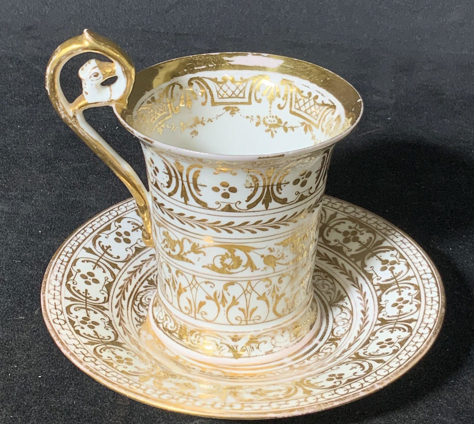 Signed Vintage DRESDEN Porcelain Teacup & Saucer: White porcelain teacup w/ saucer. Gilt line work throughout. Decorative handle, interior of cup features more gilt line work. Underside signed, reads: DRESDEN, Germany. Dresden crown symbol visible as