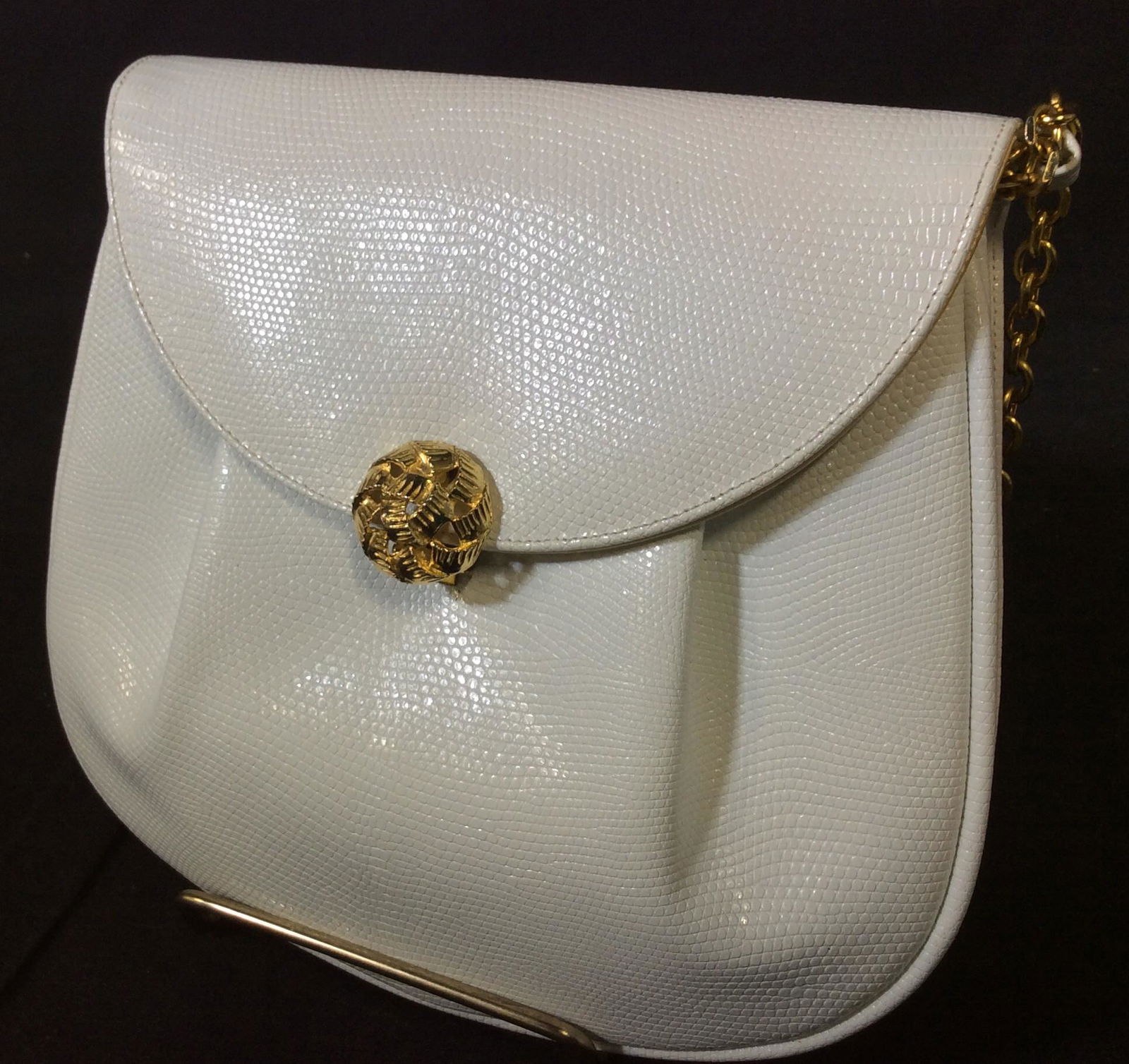Saks Fifth Avenue WHT Leather Shoulder Bag: Gold tones chain that also tucks into purse, used as clutch. Creamy white, not fabric issues, snakeskin pattern, possibly leather, flap folds over with pierced gold tone Button clasp. Interior lined.