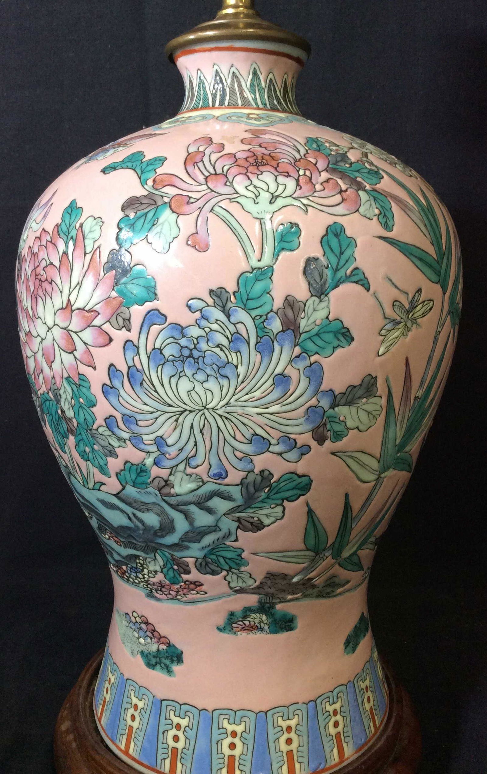 Asian Famille Rose Pink Porcelain Lamp, Hong Kong: Table lamp with embossed patterns of Famille Rose, cherry blossoms, dragonfly in nature. Light pink porcelain accented by colors of teal, violet, cream , and greys. Attached to Chinese wooden stand. N