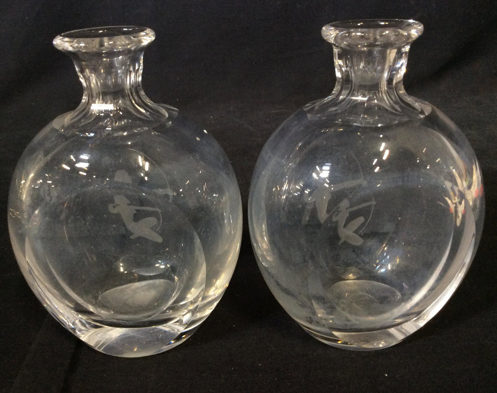 Pair, Frosted Nude Huntress On Glass Bud Vase: Thick Walled and Hand For Ed Glass Bud Vases, possibly vintage, narrow cut glass neck with larger body. Frontside has frosted silhouette of nude woman with bow and arrow. 6 in ht. 4.5 in wide, 3 in de