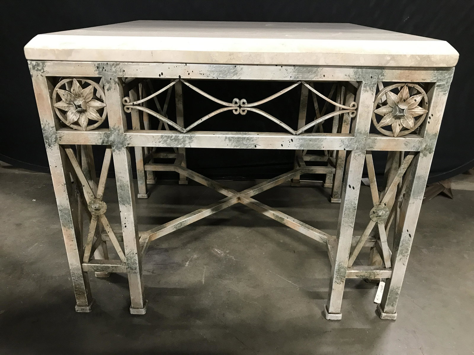 Vintage Marble Top Metal Side Table: Side table has cream toned marble top. Table is square shaped. Piece appears to be vintage. Legs have stretchers, and corners of legs have medallion detail. Piece measures approximately 23 inches tall