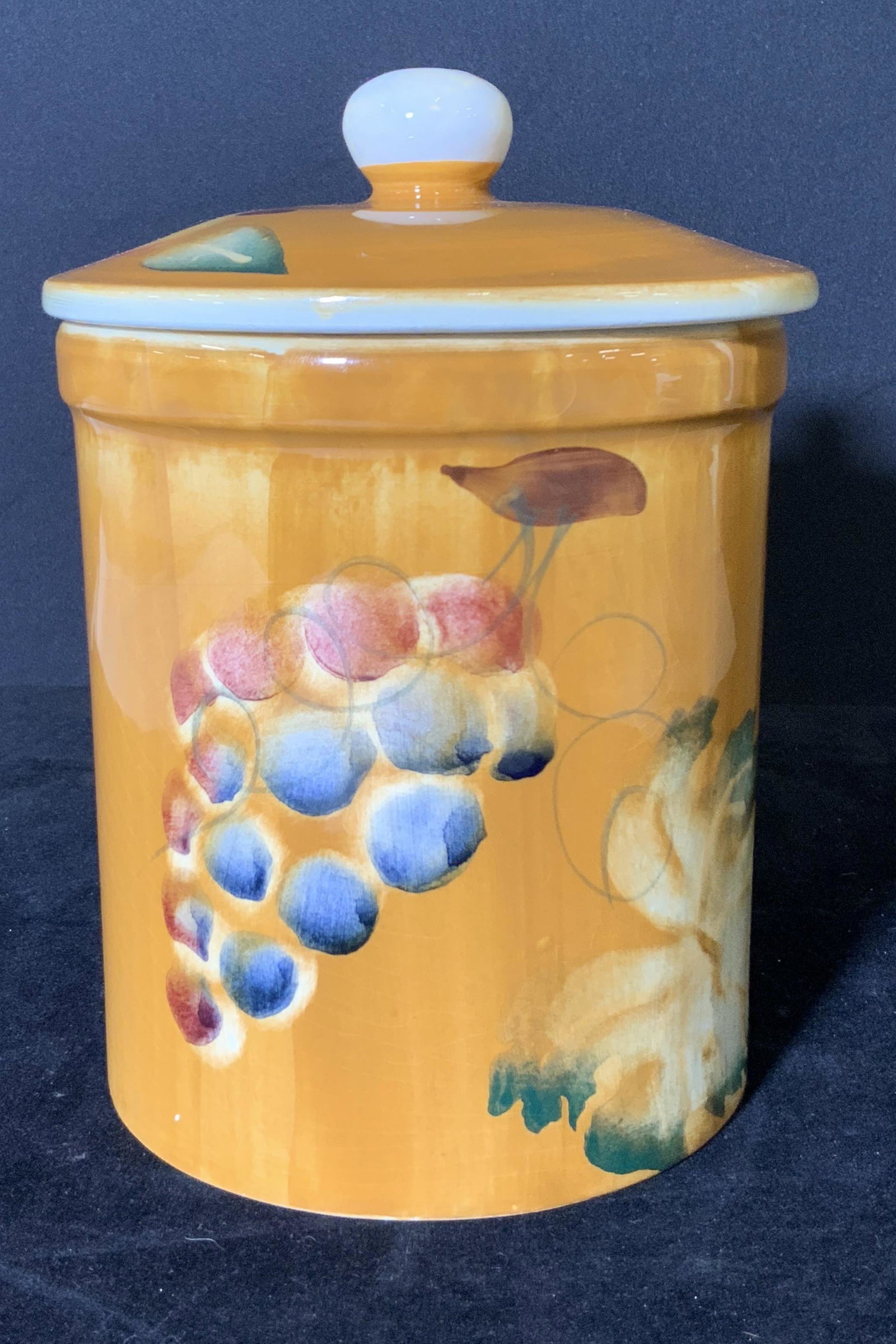 Vintage CERAMICA Hand Painted Biscuit Jar, Italy: Earth toned ceramic biscuit / cookie jar featuring hand painted fruit (peach, grape, pear). Underside stamped: Ceramica Made in Italy, Hand Decorated, Dishwasher Proof. Some crazing throughout piece. 