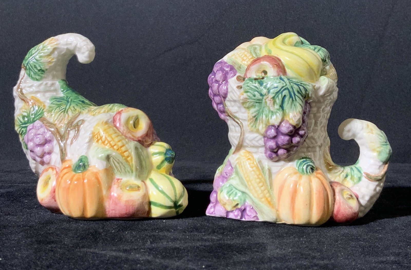 OCI Ceramic Cornucopia Salt & Pepper Shakers, Pair: Salt & Pepper shakers shaped like cornucopia/ horn of plenty. Various fruits and vegetables embossed (grapes, pumpkins, squash, apples, corn). autumn decor. Underside sticker reads: OCI CHINA. Impress