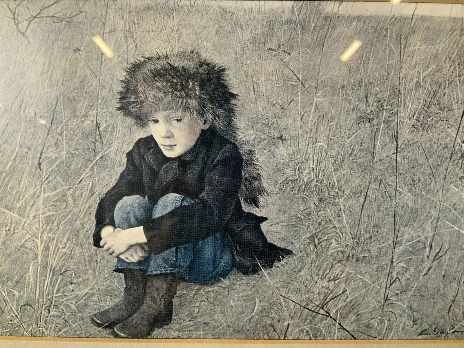 Andrew Wyeth Rural Scenes Offset Lithograph: Andrew Wyeth Rural Scenes Offset Lithograph, inscription to reverse reads ‘4277’, subject a seated boy and a farm, measures 17 5/8 x 13 5/8 inches, wooden frame painted black and gold, frame has s