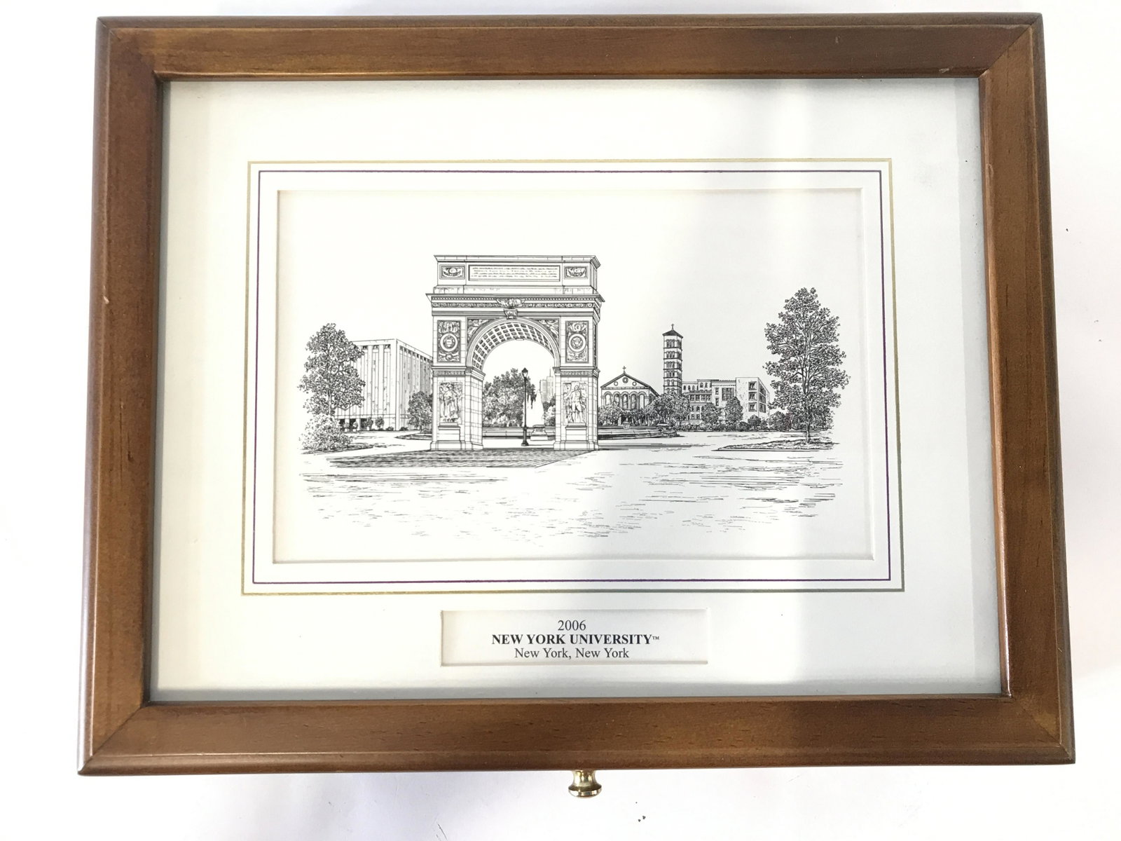 New York University Wooden Keepsake Box: Keepsake box has depictions of New York University and reads 2006 NEW YORK UNIVERSITY NEW YORK, NEW YORK on lid. Piece has small gold toned metal knob style handle for lid. Interior has mirror. Piece 