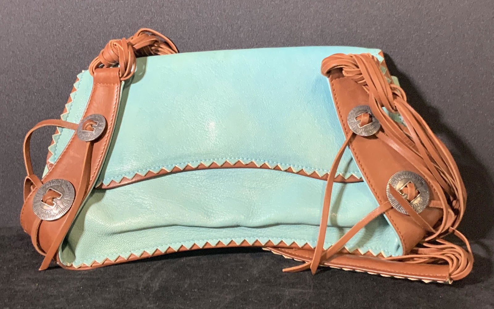 Leather Roberto Cavalli Brown & Teal Handbag Italy: Luxury Robert Cavalli Made in Italy handbag w/ two pockets and fringe straps. Silver toned hardware reads Roberto Cavalli Firenze. Sawtooth design trimming. Interior fully lined with zebra patterned t