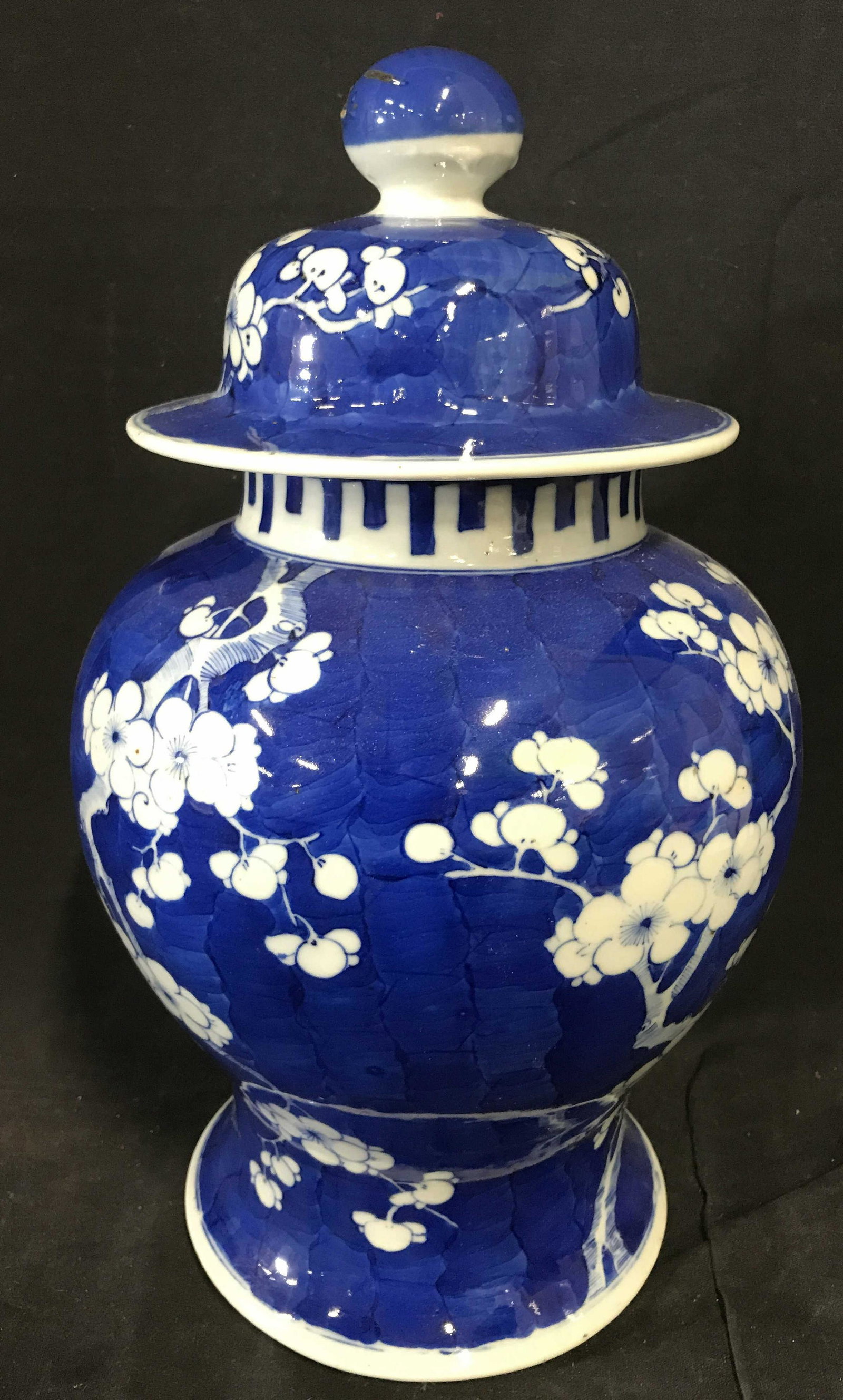 Vintage Asian Blue and White Ceramic Ginger Jar: Vintage ceramic ginger jar. All over floral pattern on a navy blue base. Measures approx 14.5 inches H, and 10.5 inches W. Wear is consistent with age and use, lid has been repaired. Ginger jar, Orien