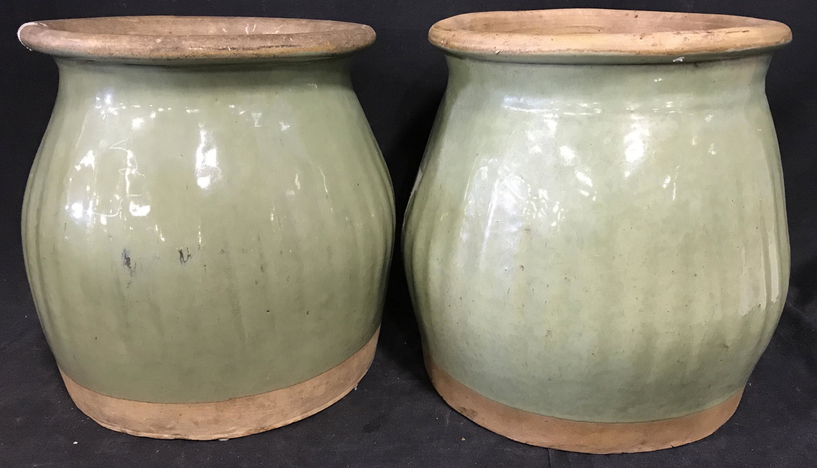 Pair Glazed Earthenware Vessels: Pair of glazed earthenware vessels. Vessels are hand painted in olive green tones. Base of vessels are unpainted and unglazed. Largest measures approx 10.25 inches H, and 9.5 inches in diameter. Wear 