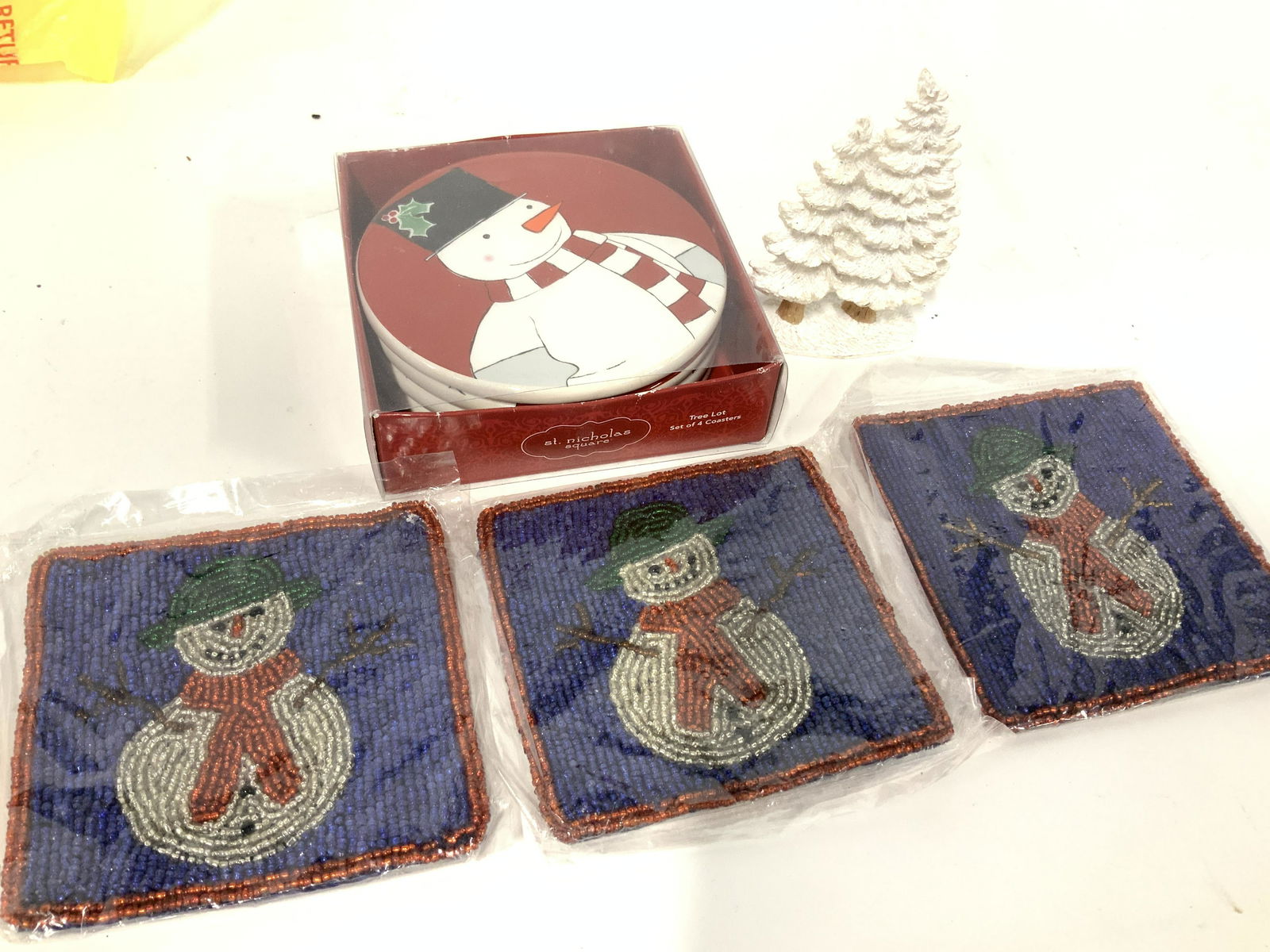 Set Beaded and Set Porcelain Holiday Coasters: New set 3 Crate & Barrel Beaded Snowman Coasters in individual packaging , 4 in. Set 4 St Nicholas Square porcelain snowmen coasters with cork underside in original box. Total 7 Christmas Coasters, Sn