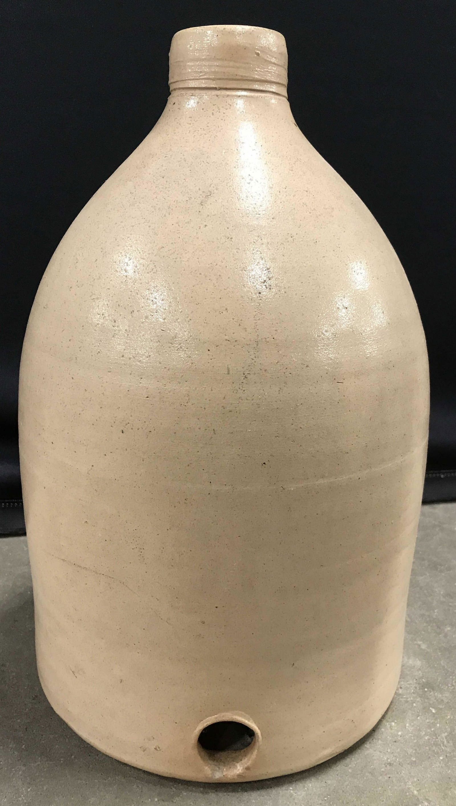 Vintage Handmade Ceramic Jug: Jug is ceramic and handmade. Piece is possibly antique. Jug has a beige tone. Top of piece has cork stopper. Piece measures approx 14 inches tall 9 inches wide. Piece has wear consistent with age. Jug