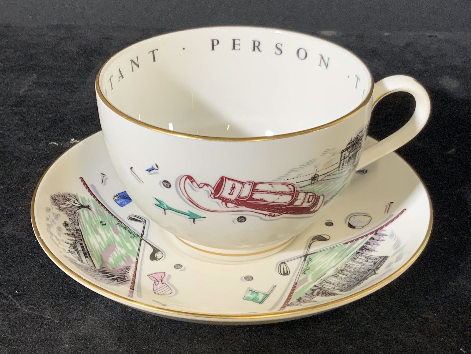 Signed Royal Worcester Porcelain Teacup & Saucer: Porcelain teacup & saucer set. Gilt line work around rims. Designs feature golf clubs and golf accessories as well as buildings with names beneath them. Some names include: Wentworth, Moor Park, St. A