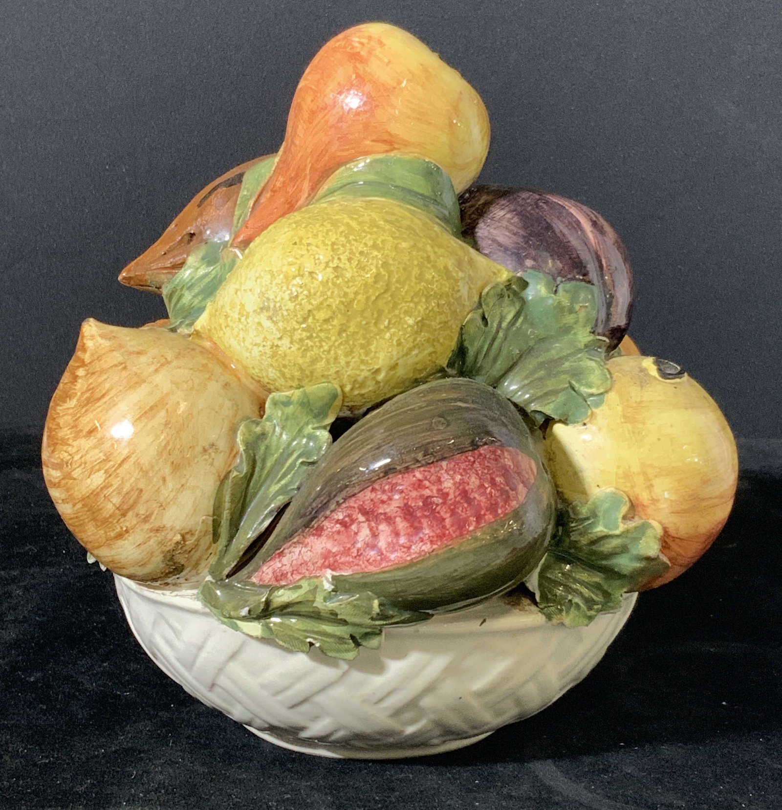 Decorative Hand Painted Porcelain Fruit Ornament: Ceramic bowl of hand painted fruit. Fruits include pears, lemons, plums, and more. Fruits sit in a white porcelain bowl with embossed weave pattern. Approx. 8 in. height. Approx. 7 in. width. Porcelai