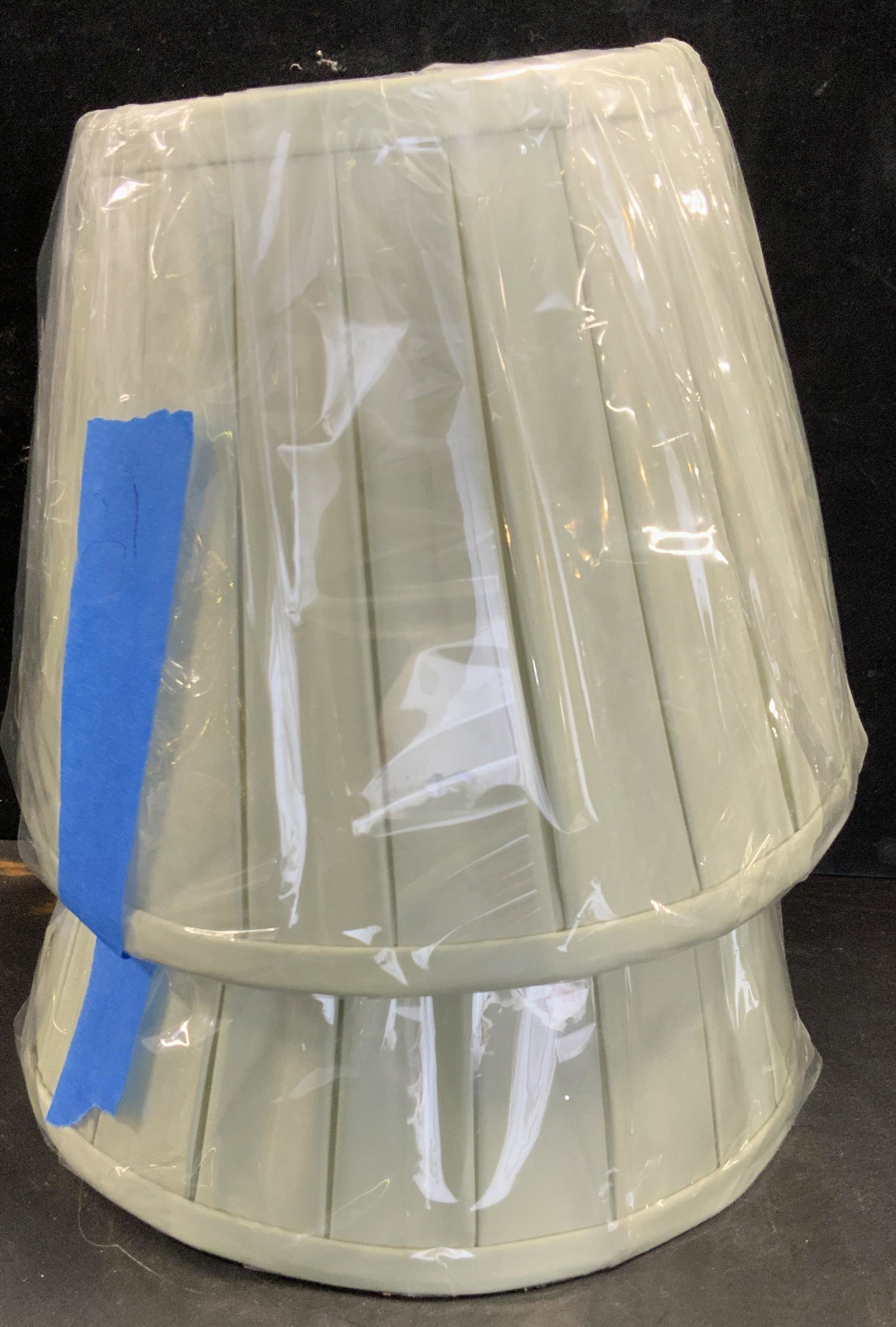 Pair 10.5 in Pleated Silk Lamp Shades, New: Brand new in cellophane packaging with original tags. Silk Pleated Empire Shades in sage green. Brass hardware. White Silk interior. Shades sit on lamp harp and are screwed down by a finial of your ch
