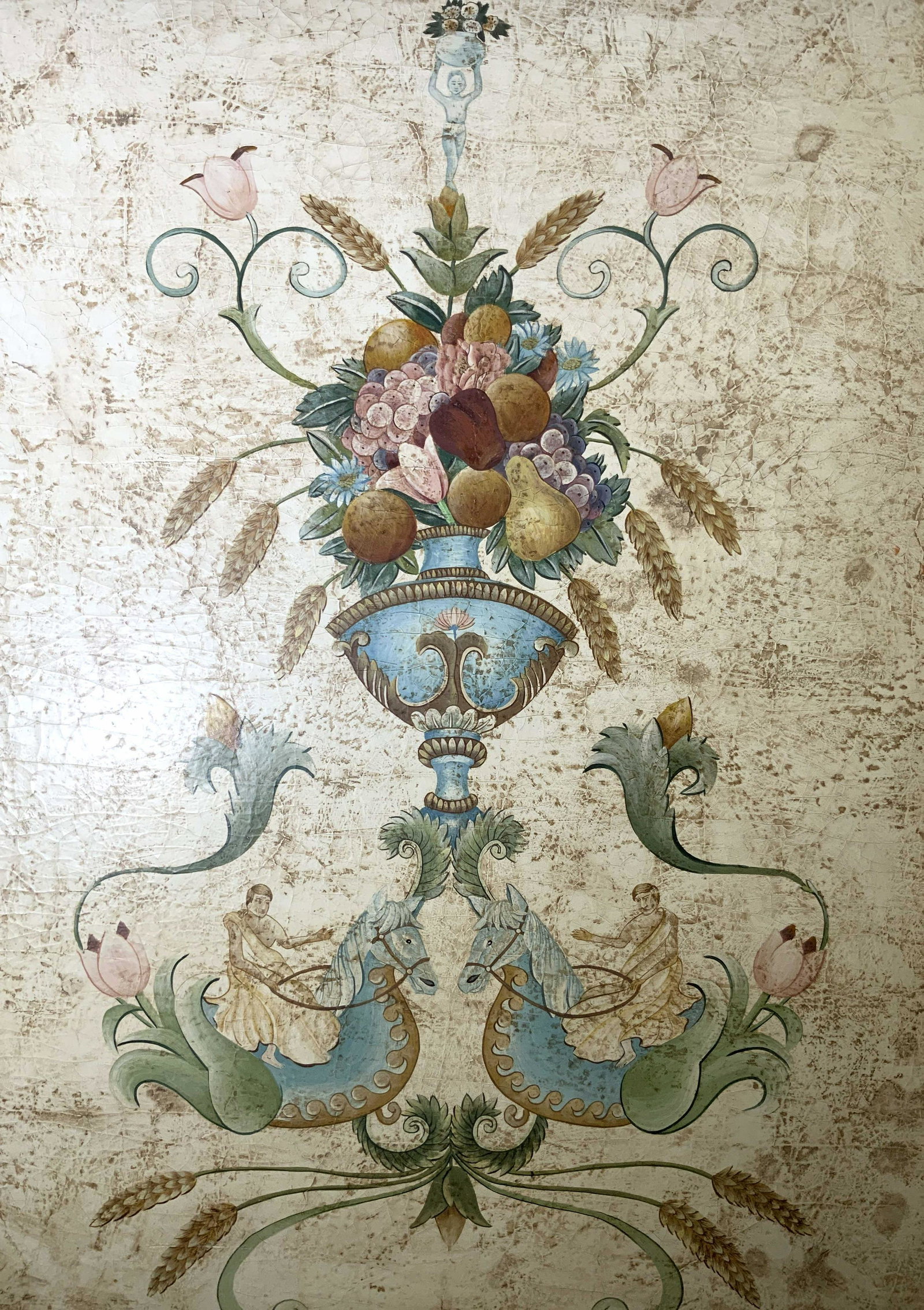 Fresco Artwork, Floral Urn Design, Kelpies: Fresco Artwork on board, possibly tempera painting, no apparent inscriptions or signatures, label to reverse reads ‘2’, subject a vase of fruit with two men on seas horses, measures 46 x 33 inches
