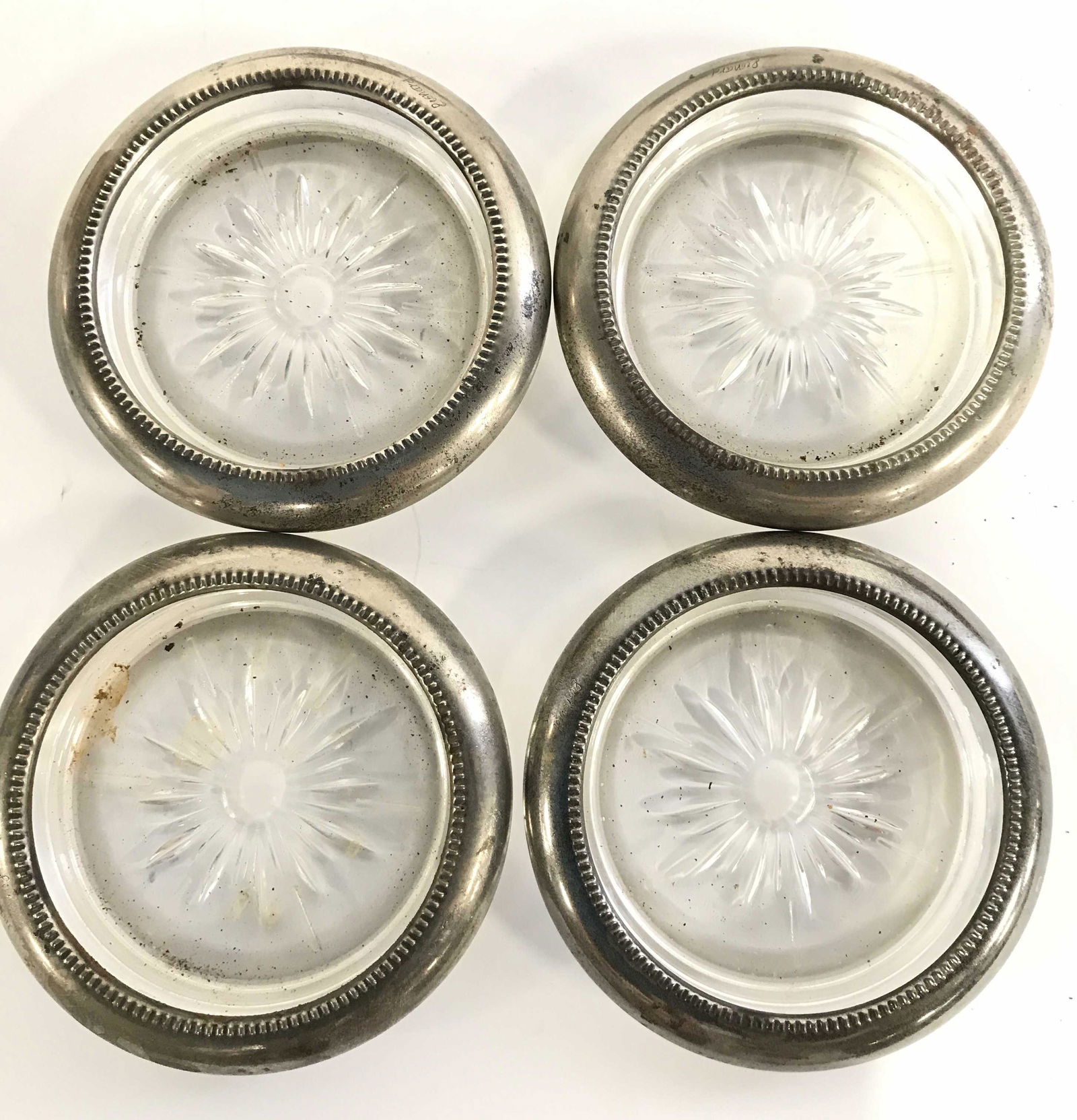 Set 4 LEONARD Cut Glass & Silver Plate Coasters: Signed Leonard Silver plate rimmed cut glass coasters, vintage, c. 1940s, 1950s. 4 3/8 in. Diameter. Some wear to metal consistent with age and exposure. Leonard Silver plate Coasters, Beverage Coaste
