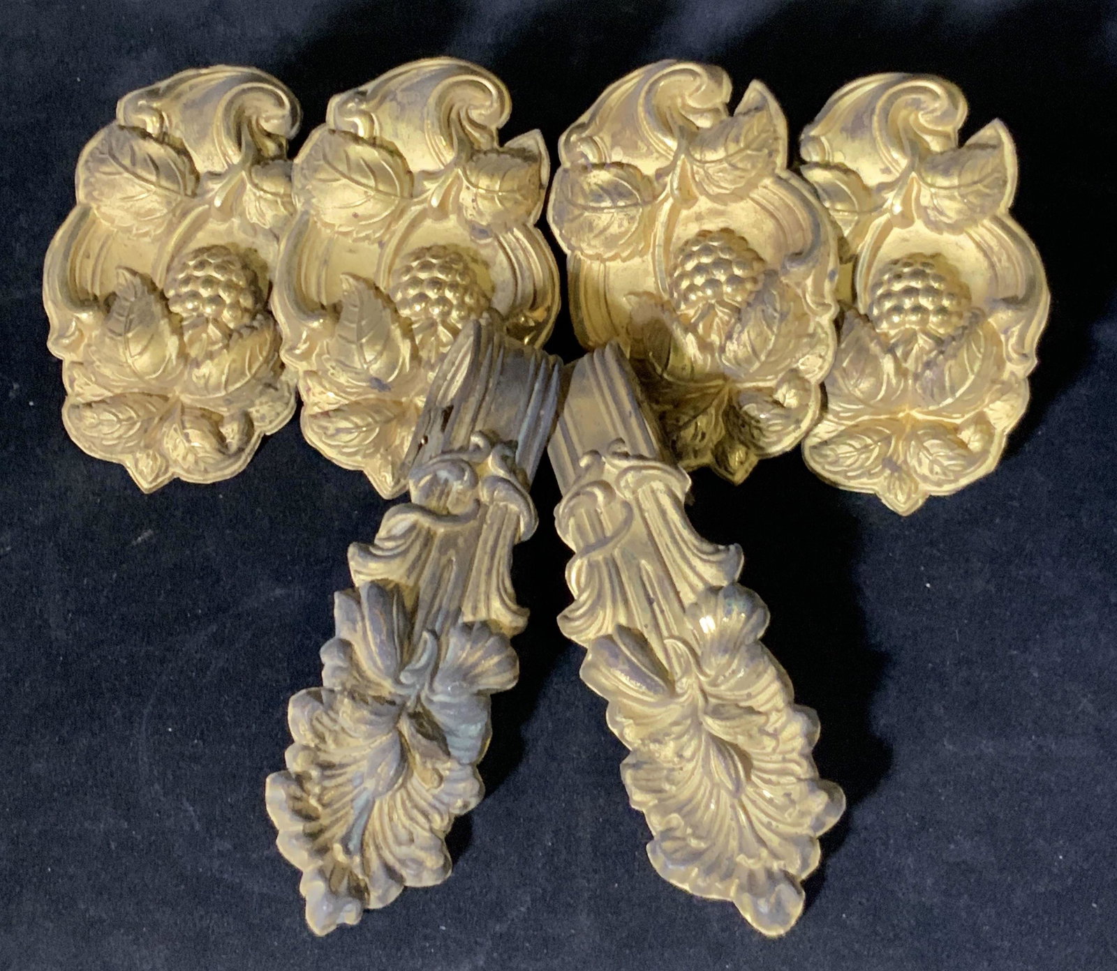 Lot 6 Gold Toned Metal Decorative Wall Hooks: Gold tone and rococo 6 metal repousse wall hooks with fruit and floral motifs. Decorative hooks for hanging on your walls, over doors, and more. Approx. 6.5 in. height. Approx. 4.25 in. width. Decorat
