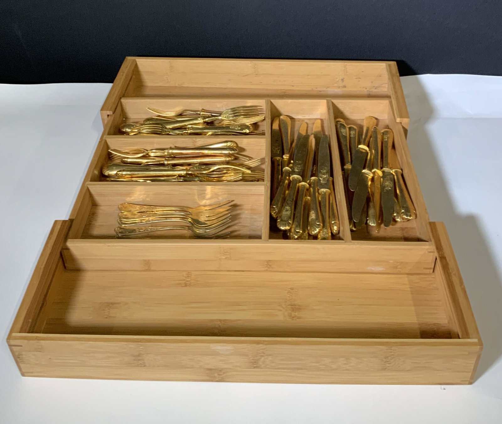 Set 50 ARCACHON Gold Toned Kitchen Flatware: Wooden utensils holder with 5 sections, expandable. Comes with forks and knives. 28 forks. 22 knives. Some forks are longer and have four prongs (22), some are short w/ three prongs (6). All utensils 