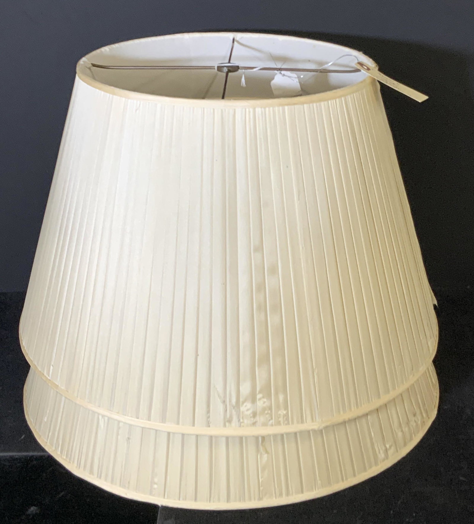 Pair Silk Large Empire Lampshades: 2 silk bisque colored lampshades from ‘ Christie’s ‘. Large empire style, ribbed design throughout. Mild tearing. Approx. 13 in. height. Approx. 20 in. width. Lamp Shade, lighting accessory, Lam